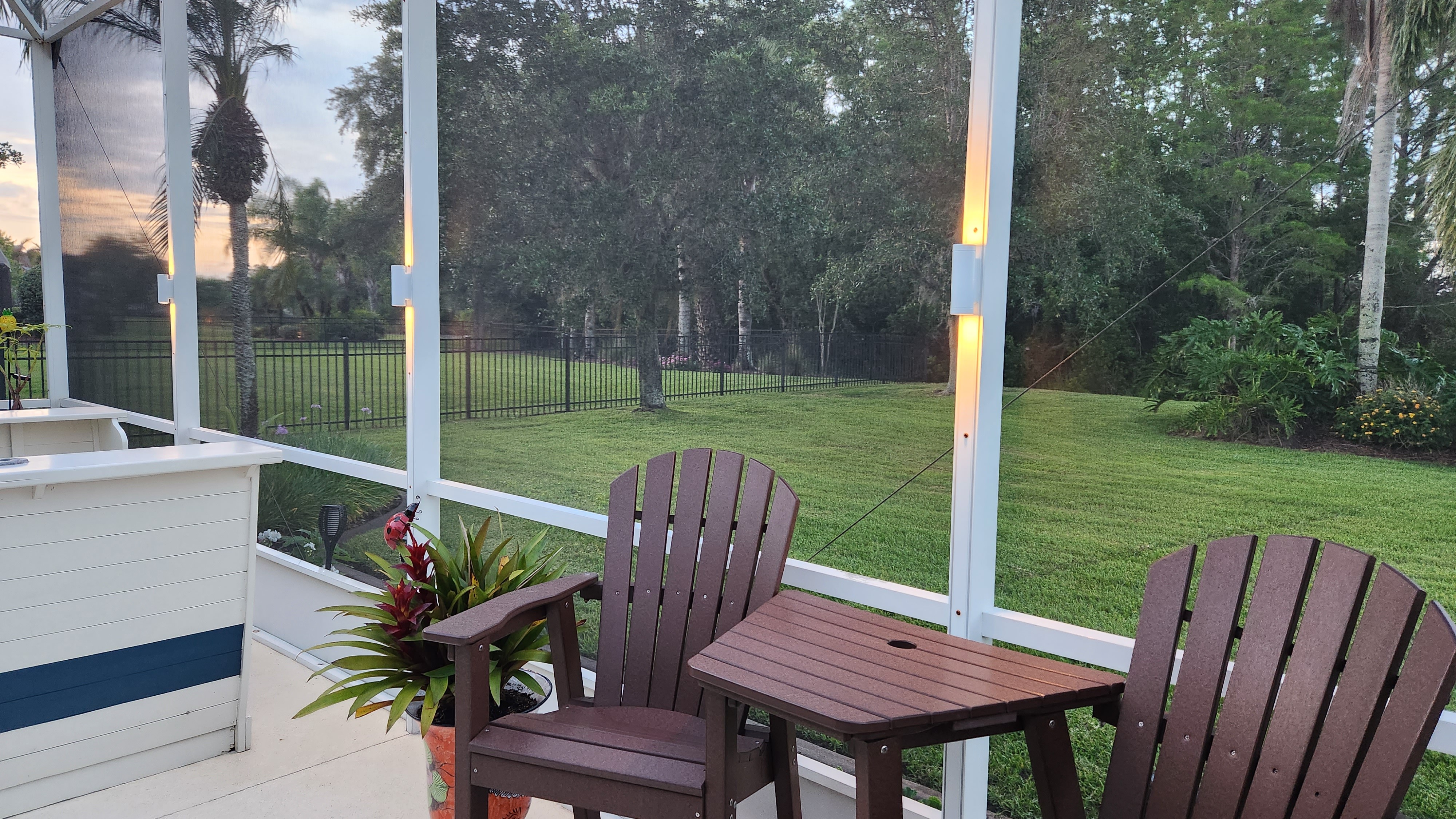 Backyard patio and pergola illuminated with warm outdoor living landscape lighting