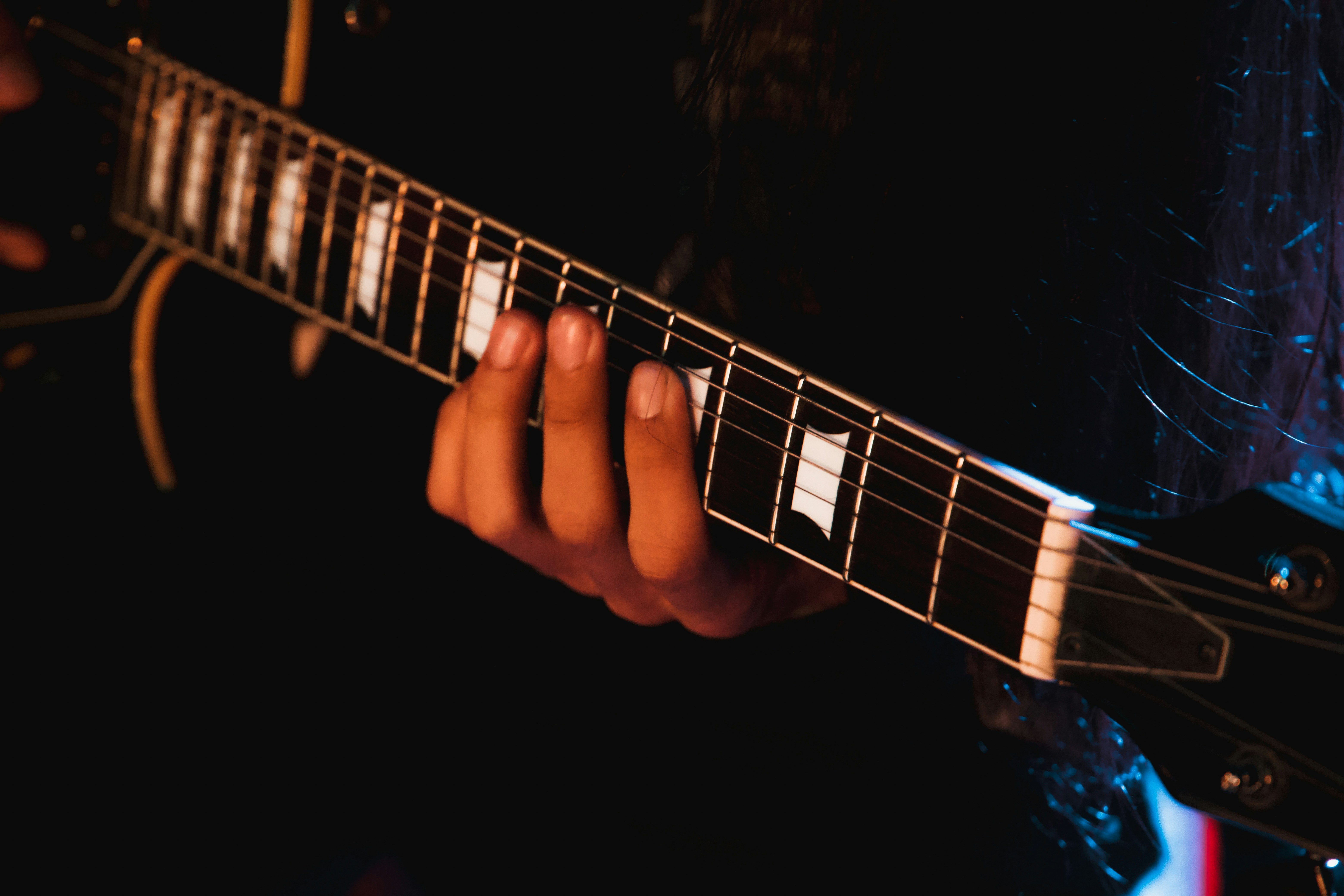 Man fretting a guitar