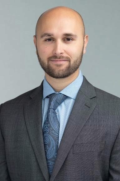 A person in a suit and tie

AI-generated content may be incorrect.