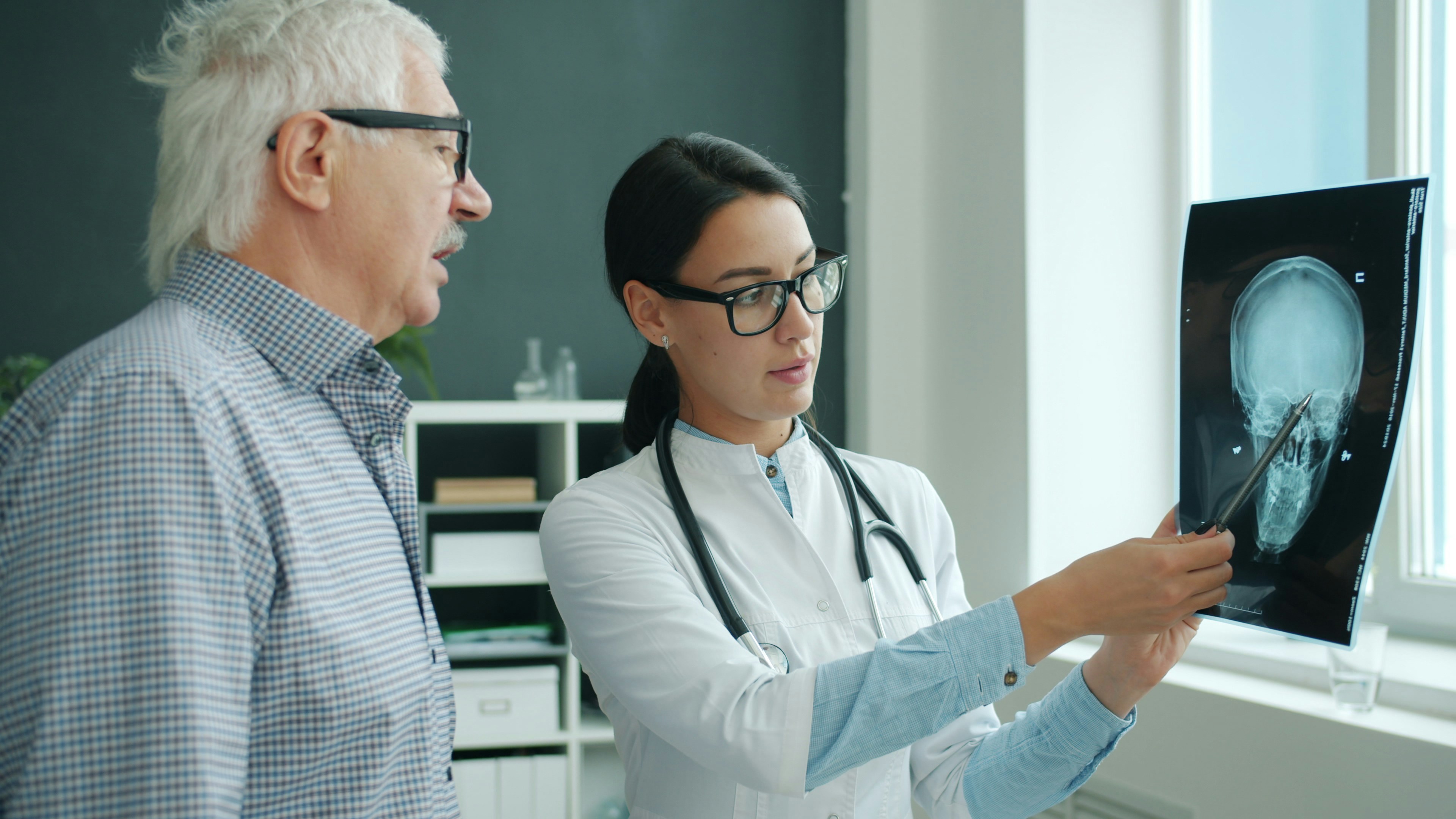 Doctor with patient checking x-ray