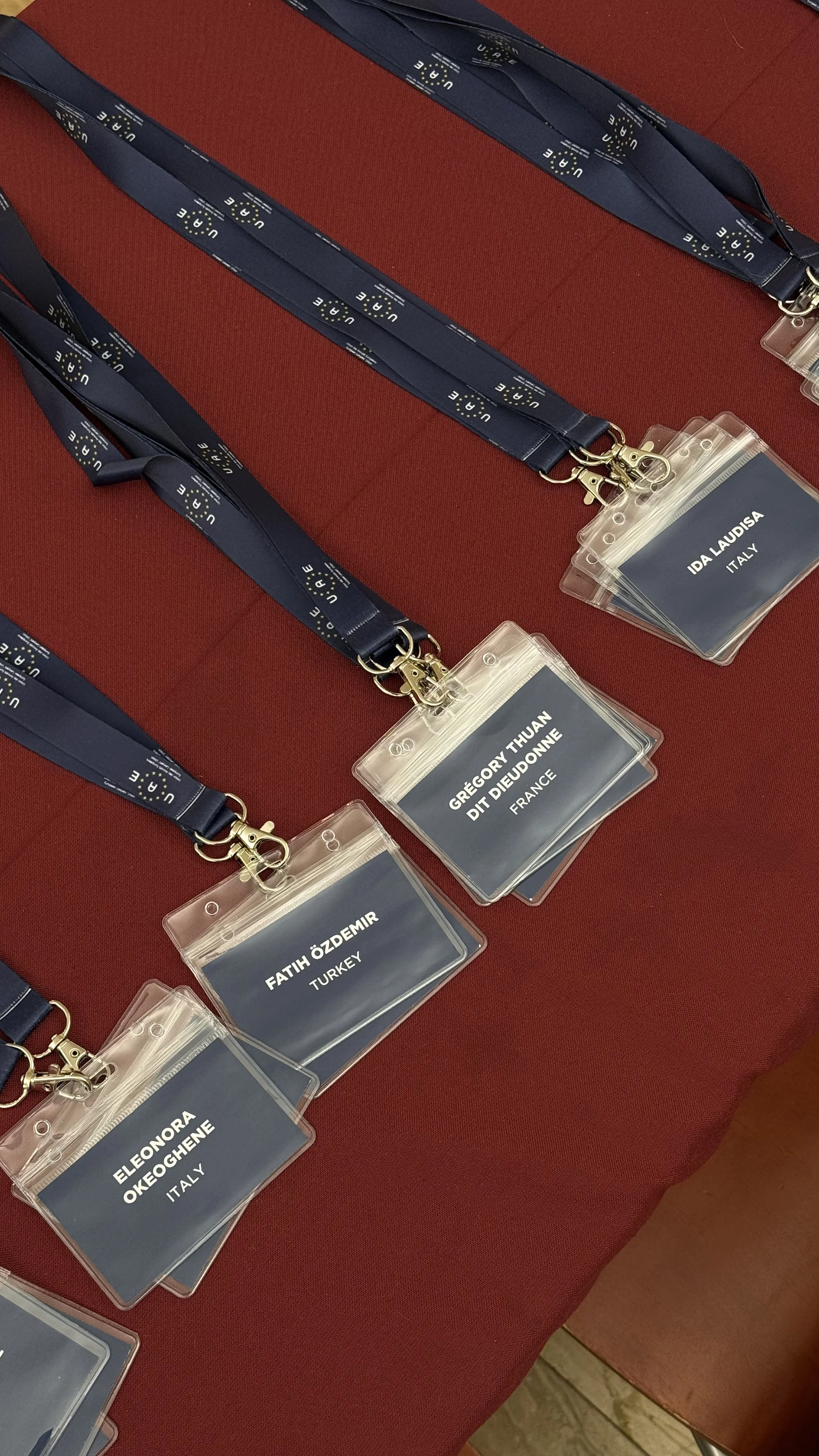 Conference badges on a red cloth