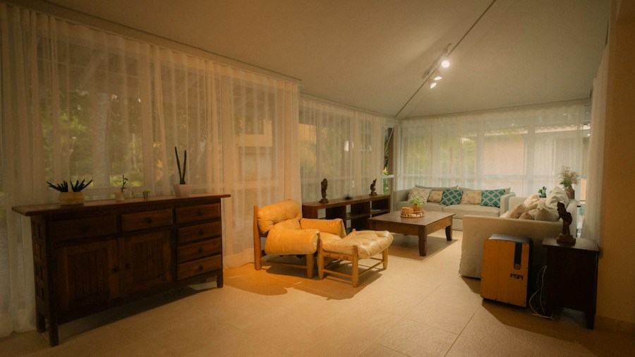 An empty, well lit sitting room with the shutters open