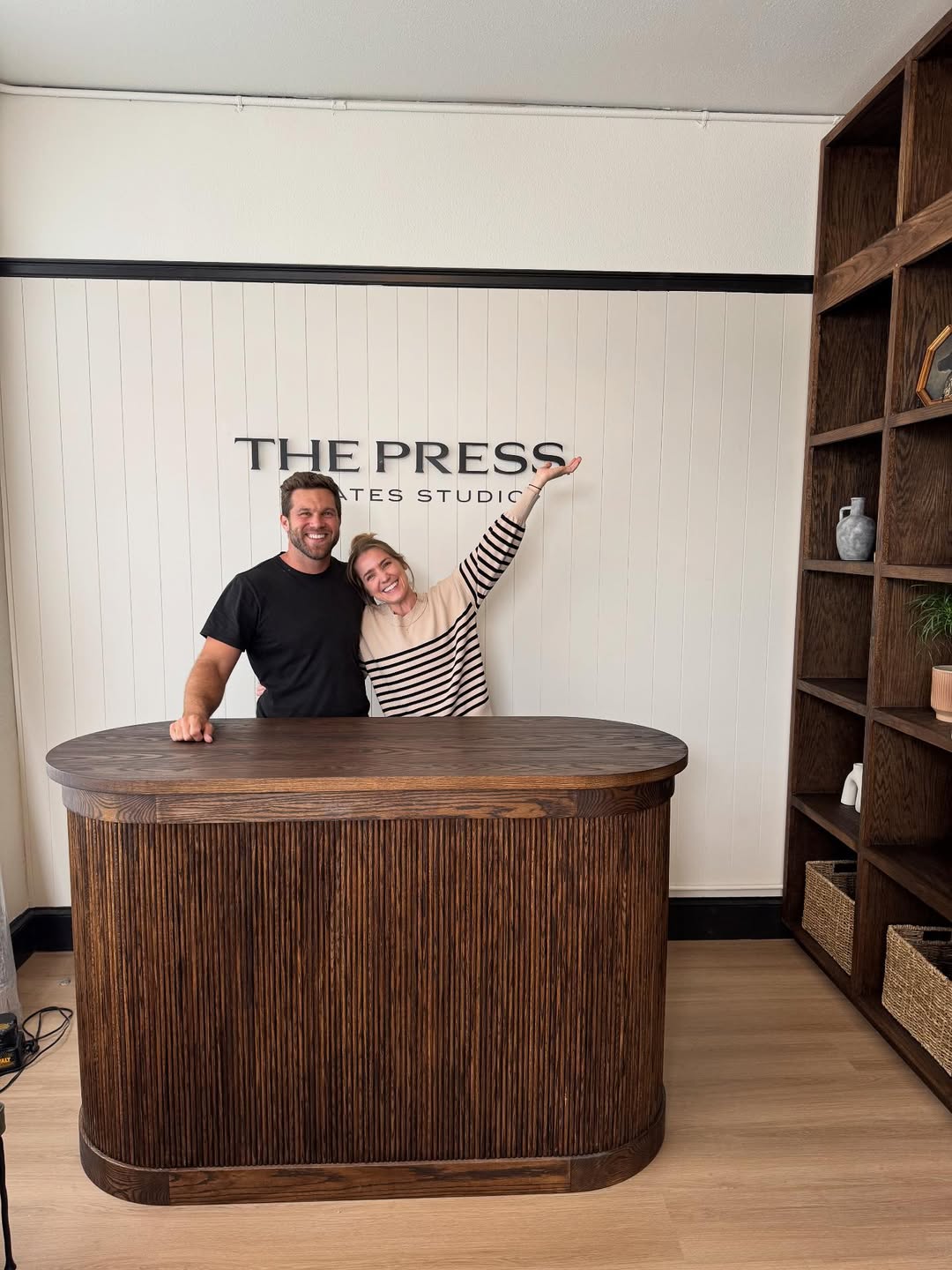 Founders of The Press Pilates standing inside their studio, highlighting the calm, community-led atmosphere of the space