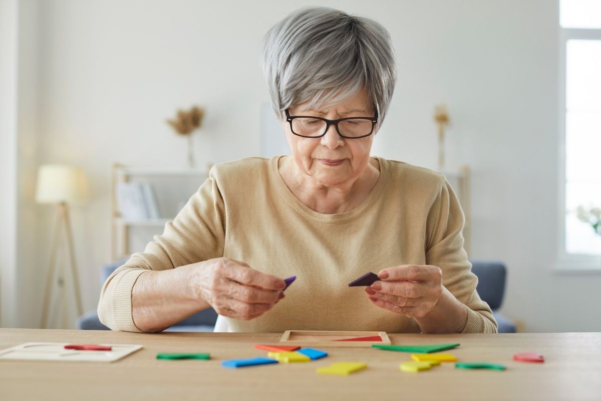 Senior woman working on sorting shapes.