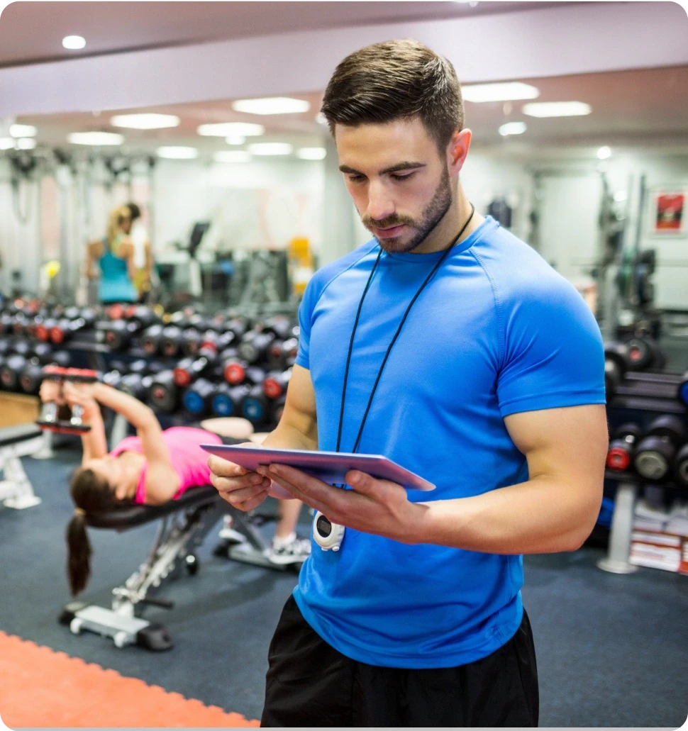 A dark cylindrical object on a wooden bar, with softly glowing lights in the blurred background.