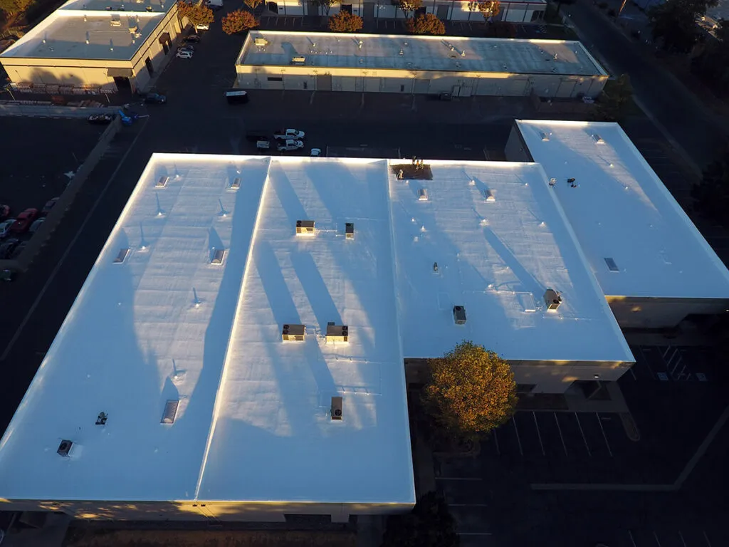 spray foam roofing system with silicone coatings