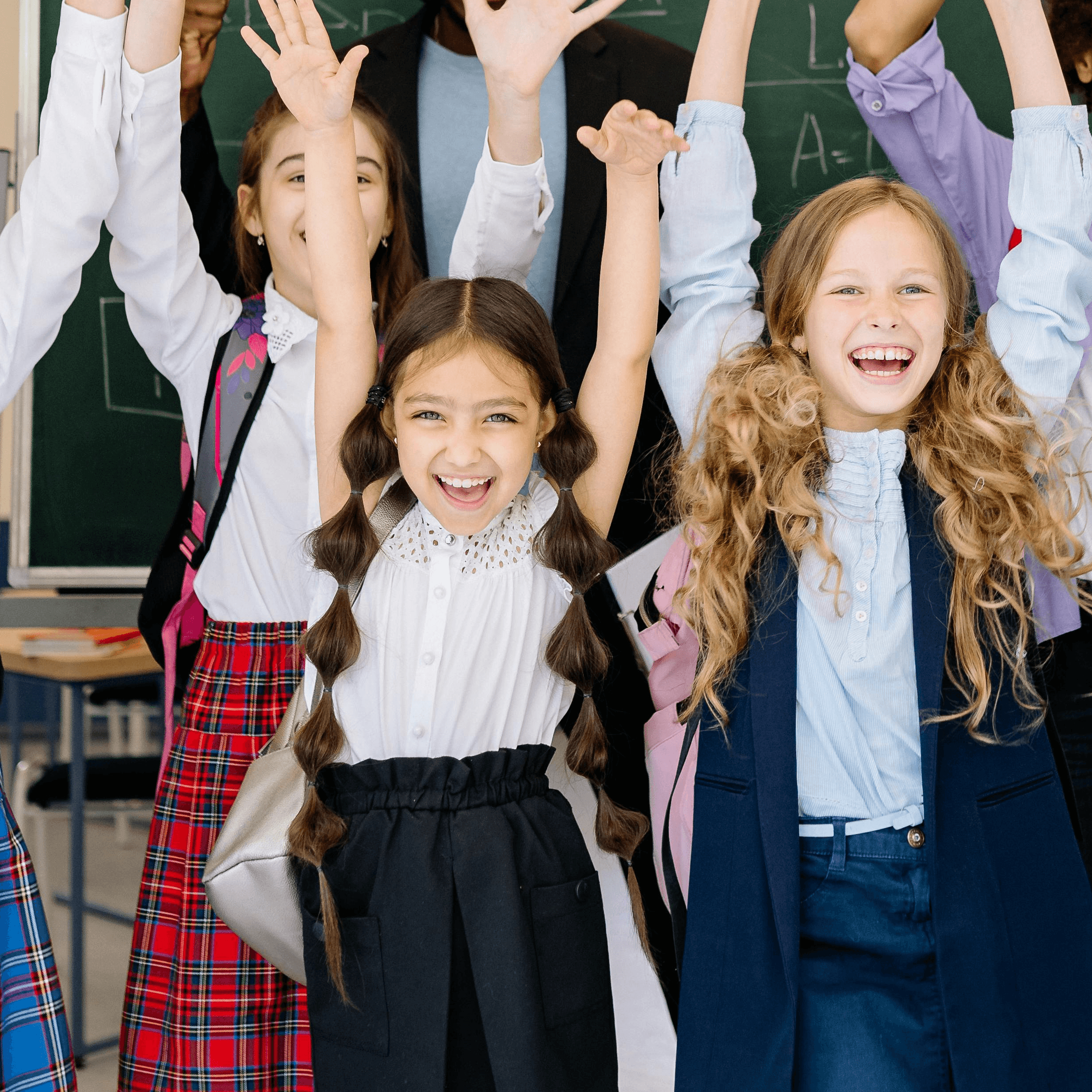 two young girls sitting at a table with markers and crayons