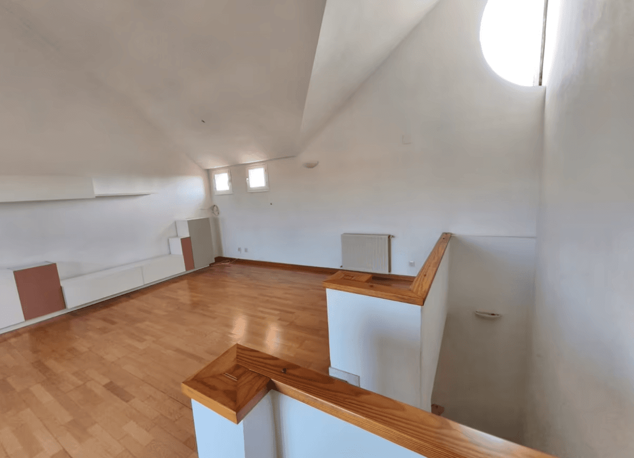 A modern brick house with a two-car garage, well-manicured lawn, and clear blue sky in the background.