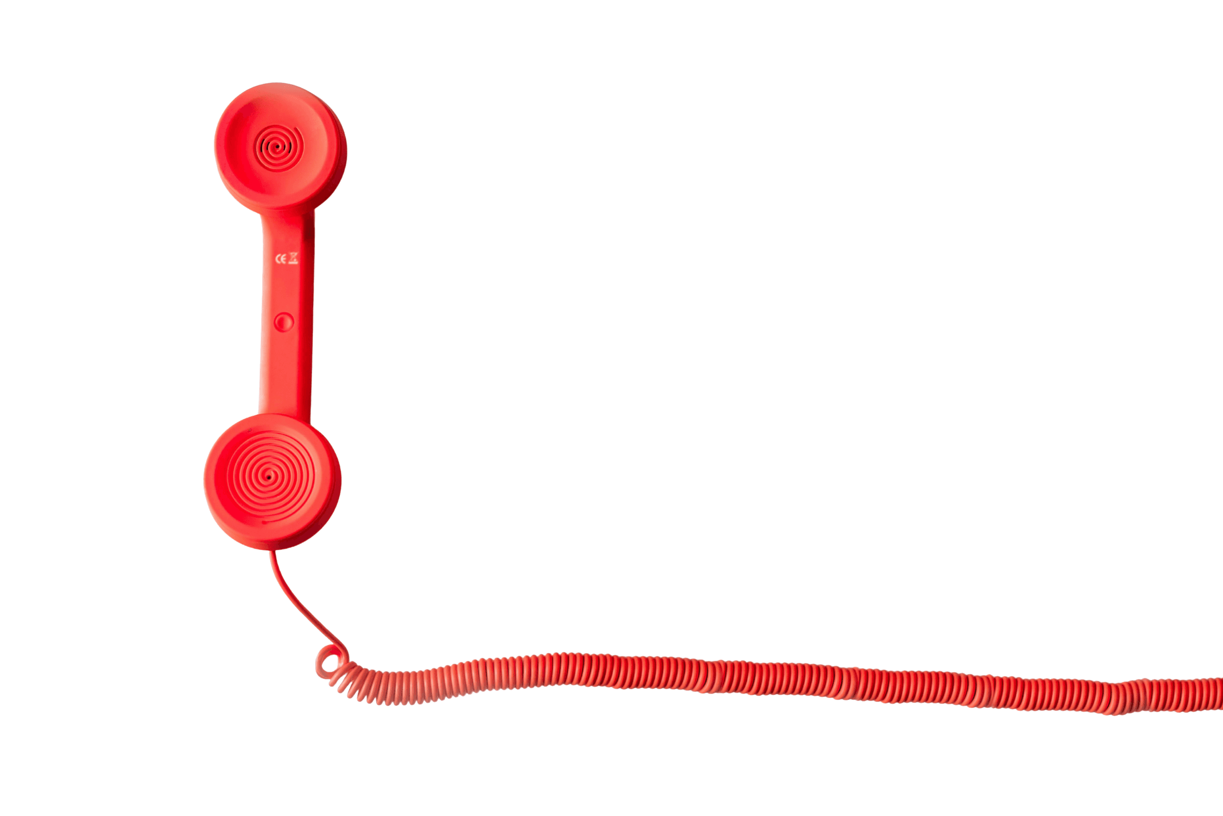 Red retro telephone receiver with coiled cord on black background.