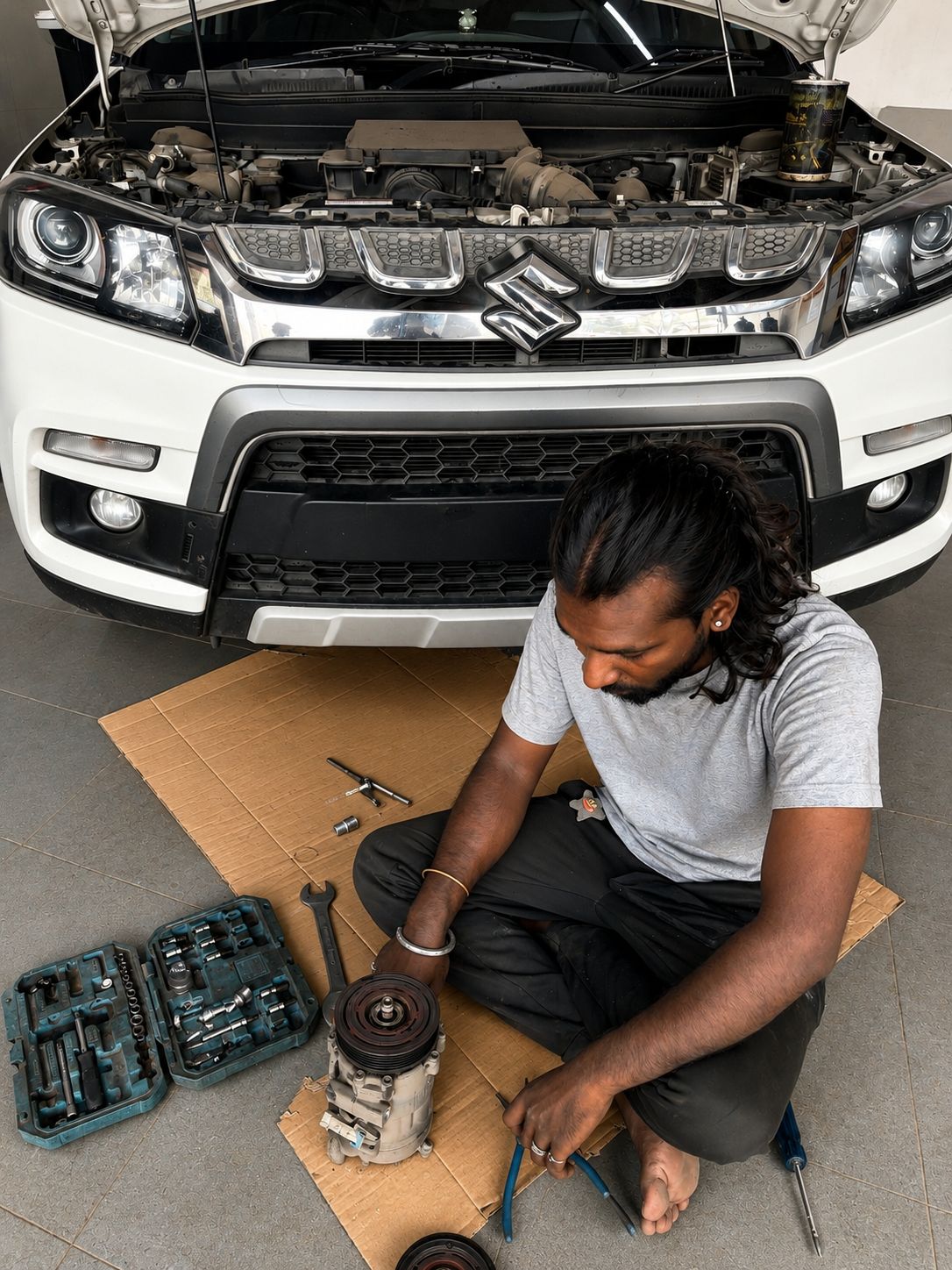 man refilling motor oil on car engine bay