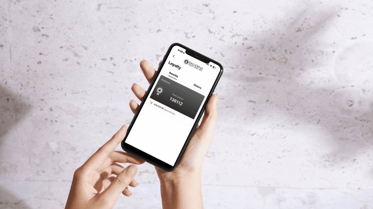 a person using iPhone to get points at Ballerina Nails and Spa