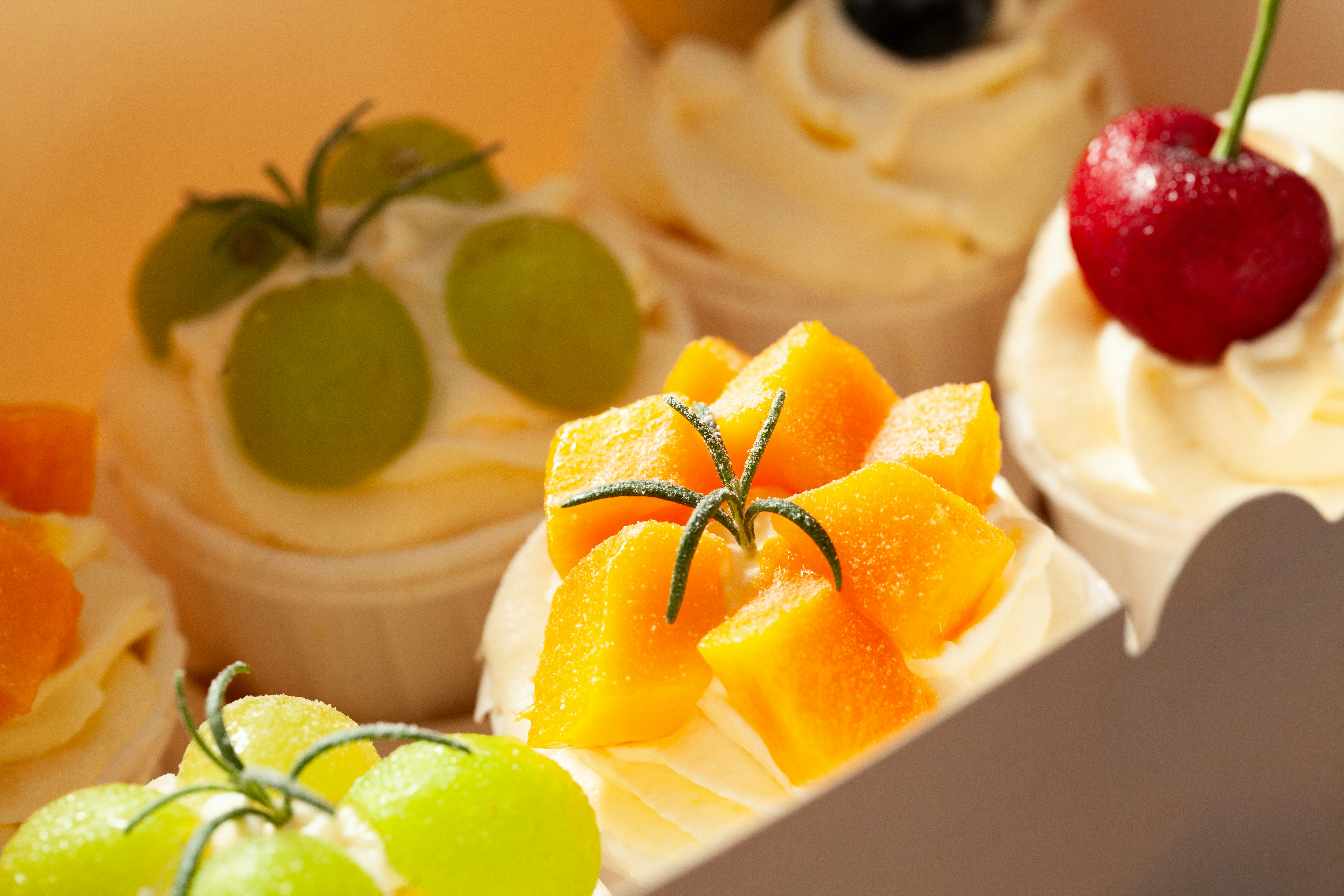 A box filled with different types of cupcakes