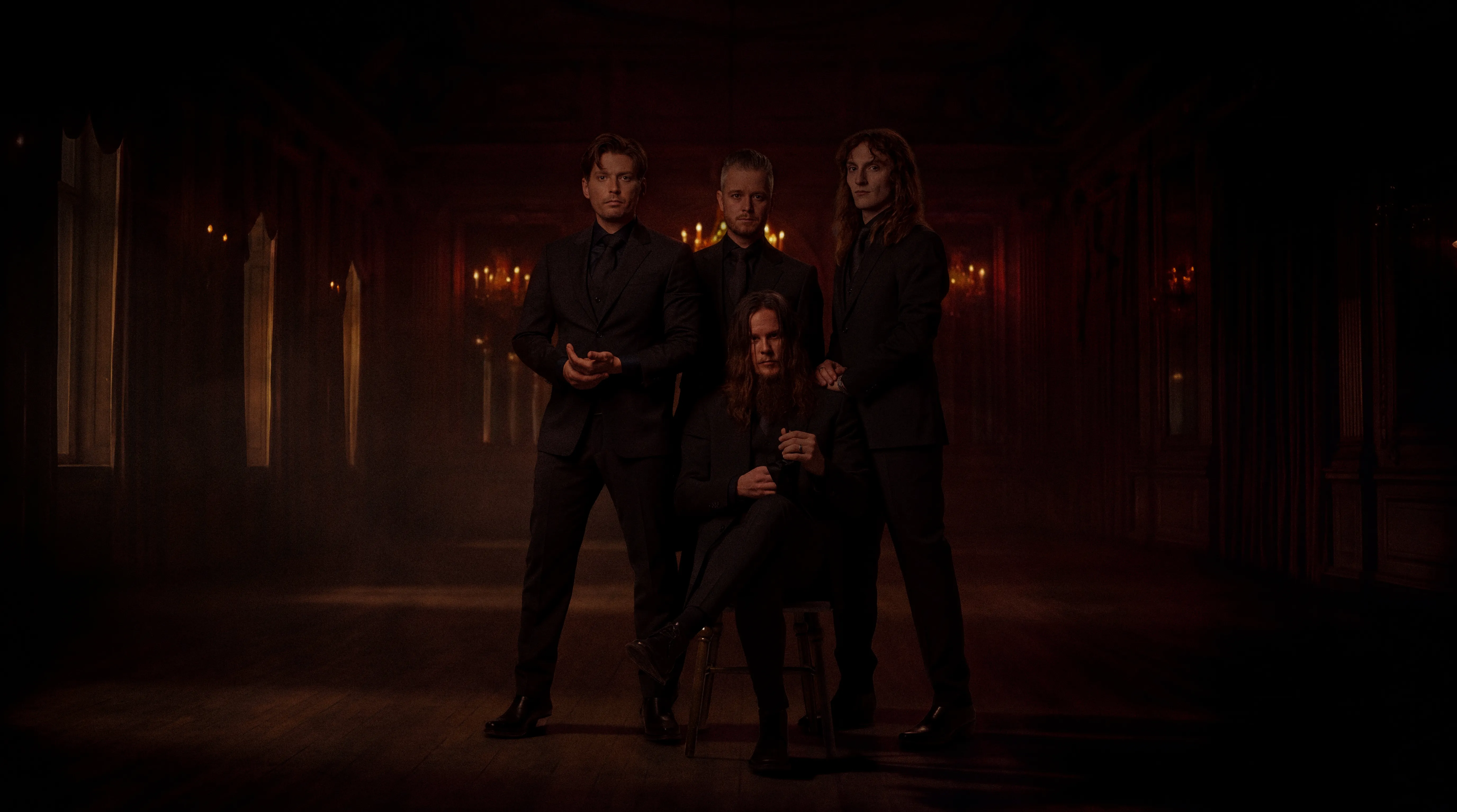 Remedy standing together in a dimly lit, ornate hall with chandeliers and columns.