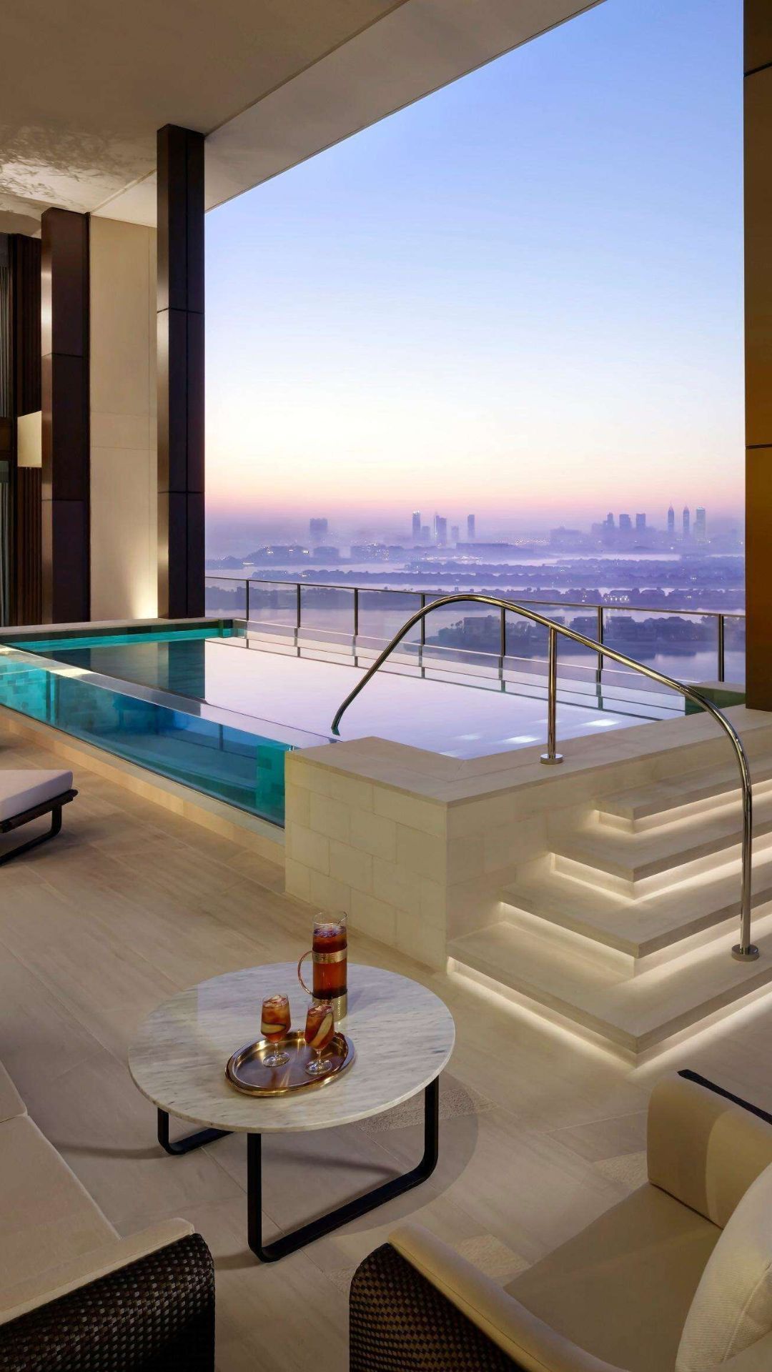 Luxury hotel terrace with infinity pool overlooking the city skyline at dusk | Lunasole Hospitality