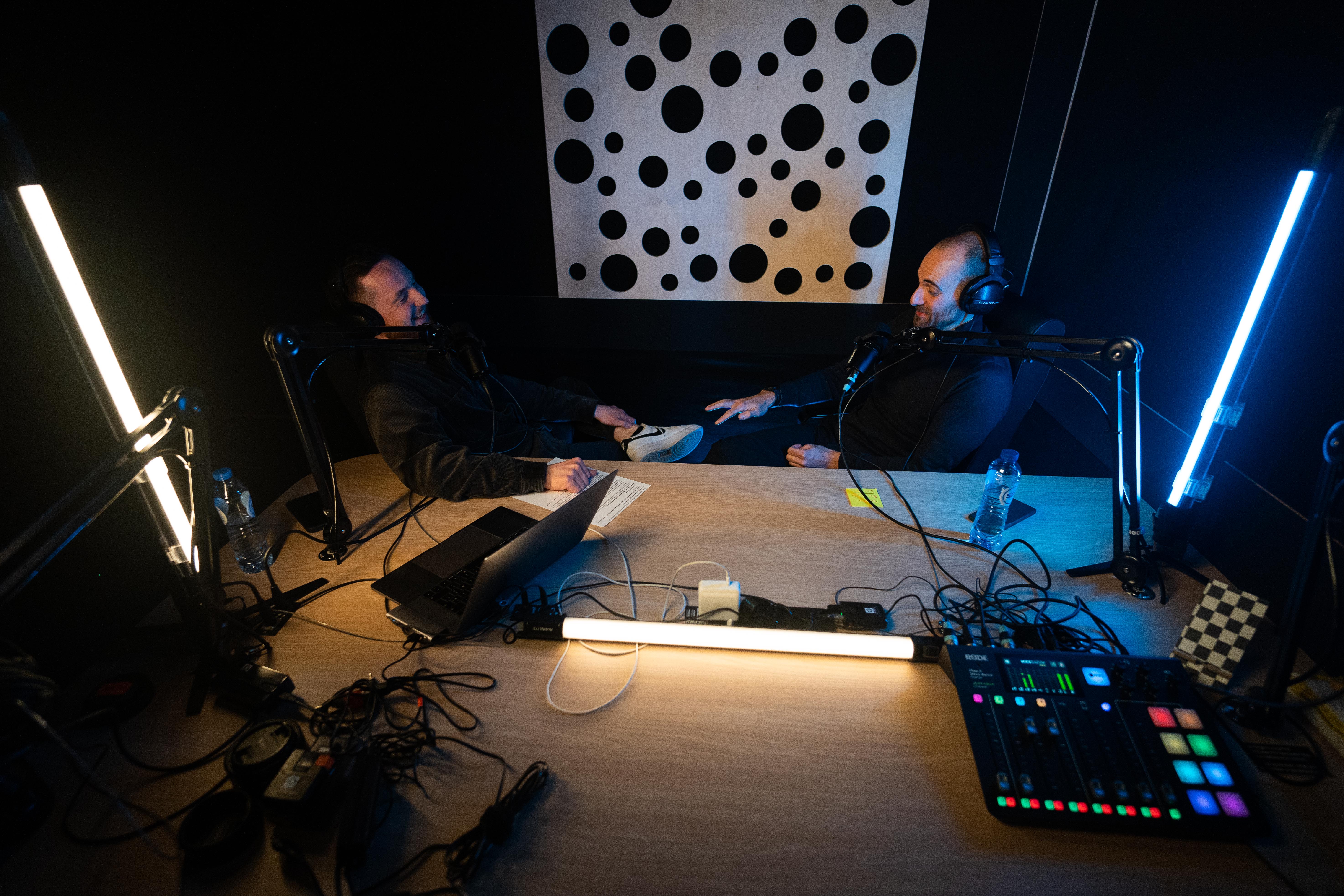 Modern home office setup with a monitor, ergonomic chair, keyboard, and indoor plants near a window with blinds.