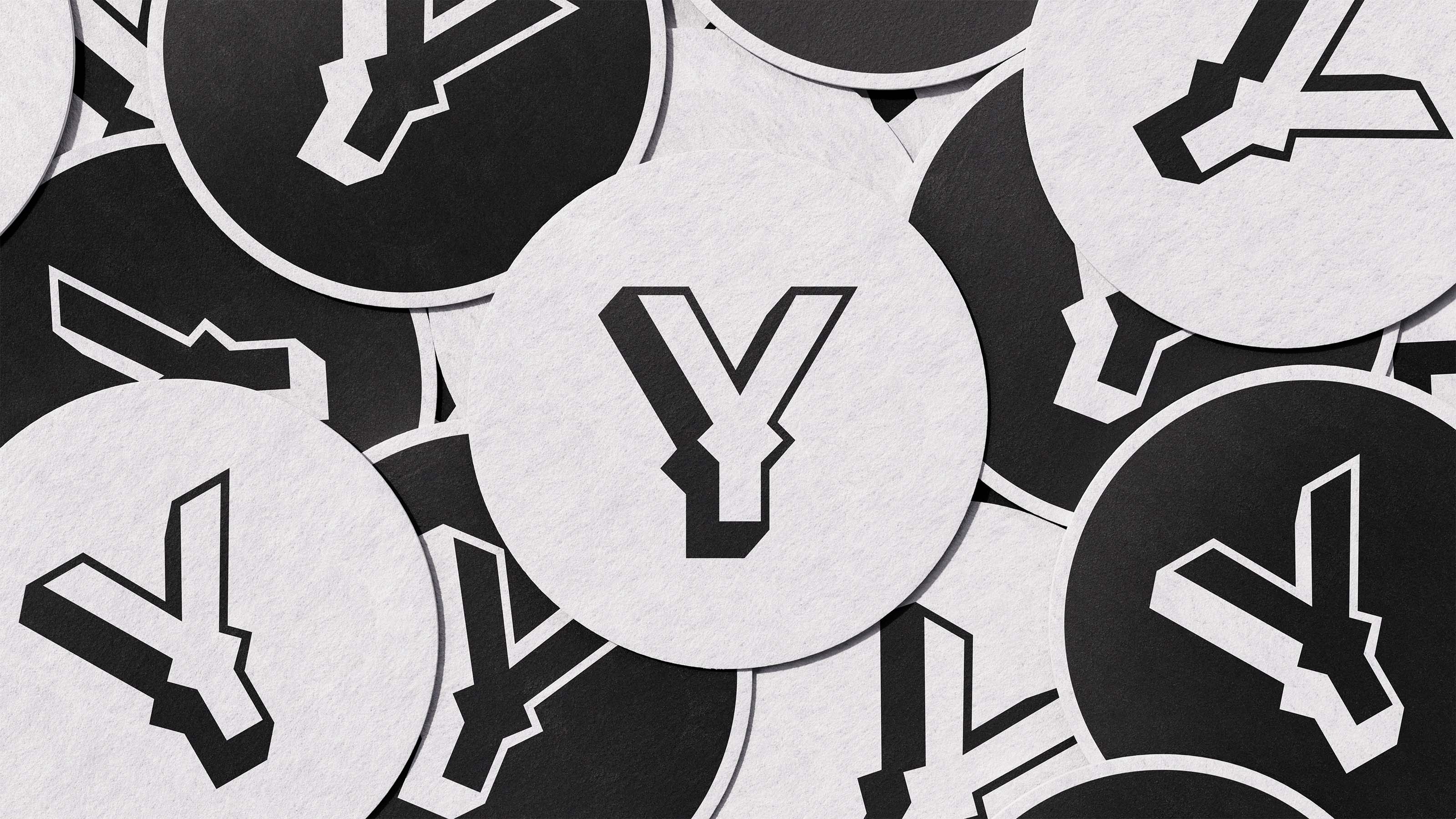 Pile of black-and-white YeeHop beer coasters featuring the brand’s lettermark 'Y'.