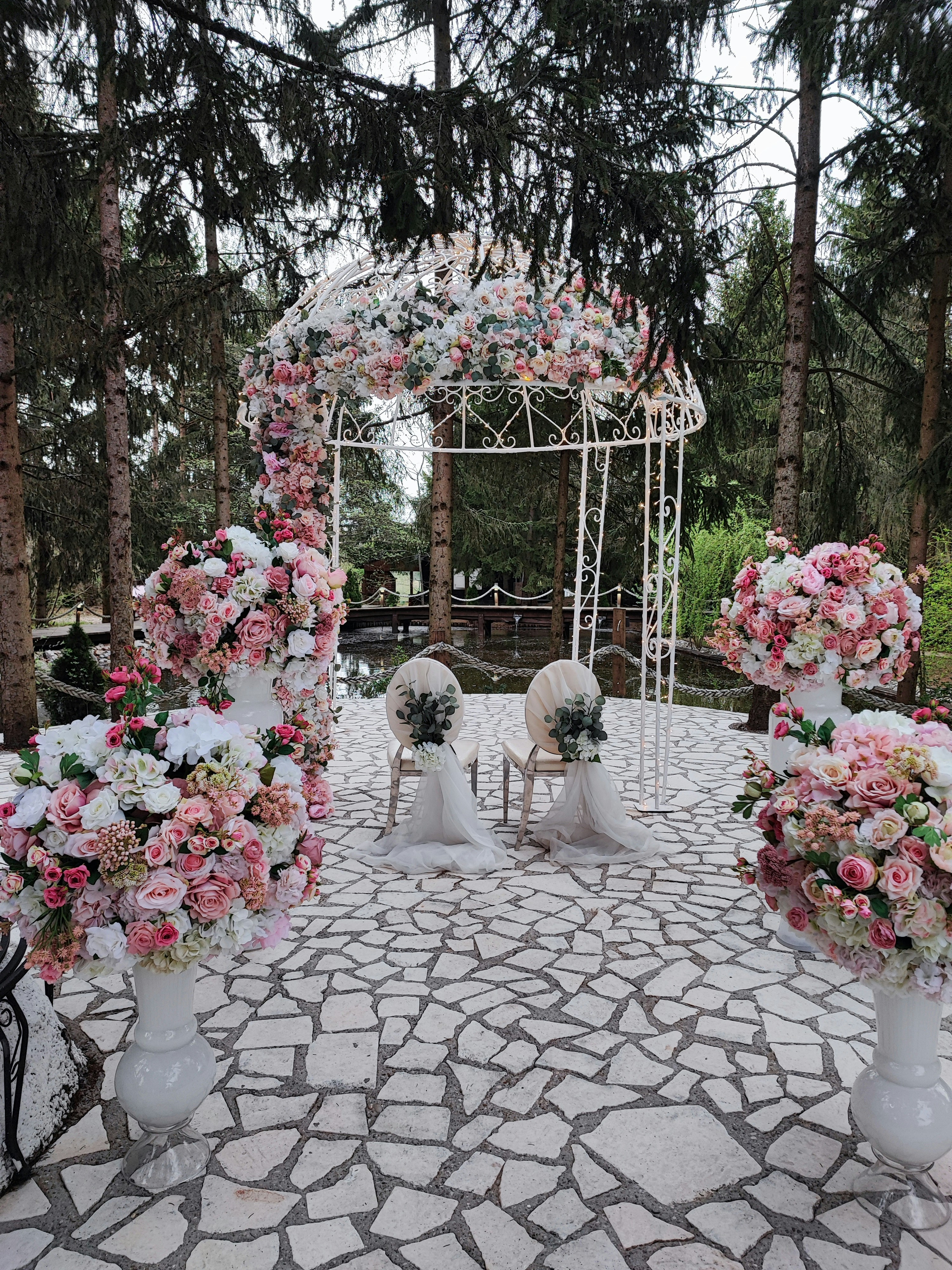 Soft peach-toned interior with curved steps, warm lighting, pampas grass, and an orange pouf.