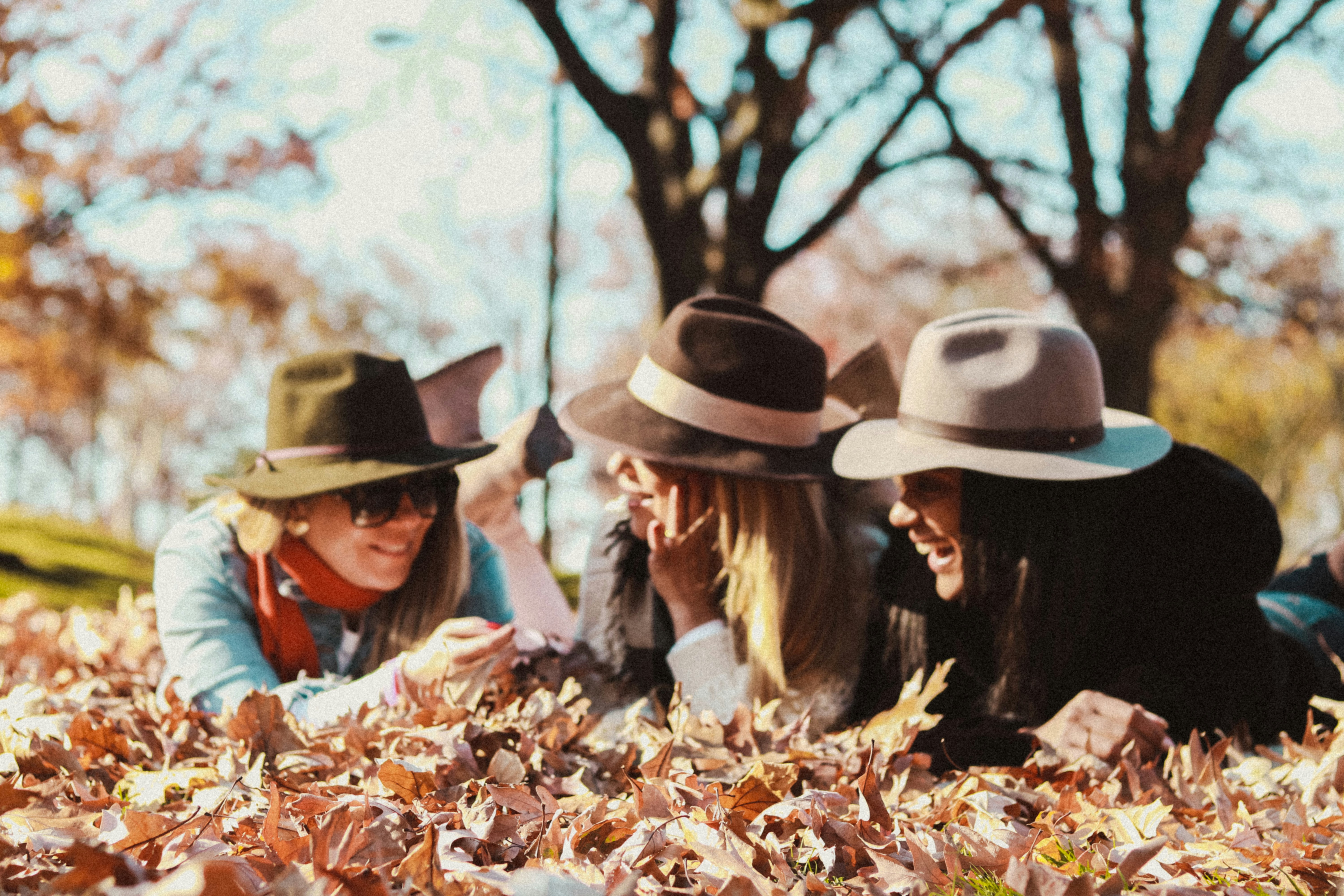 Girls Laying on Leaves- Fall Senior Picture Outfits