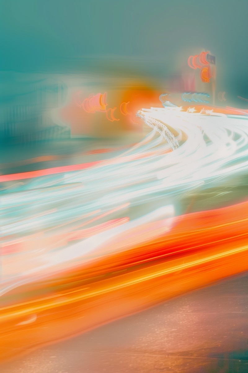 A dynamic, abstract image showcasing streaks of vibrant white, red, and orange light trails against a soft, blurred background, capturing the motion and energy of a bustling urban scene at night.