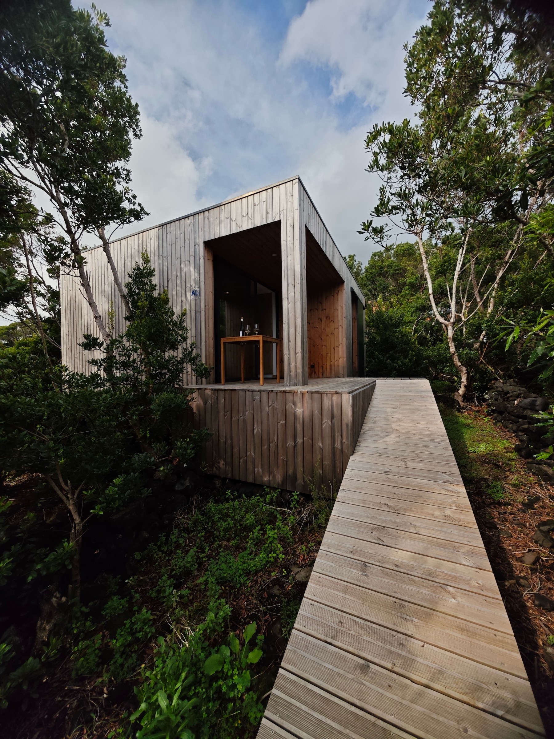 Exterior view of Misterios Lodge access ramp and deck surrounded by trees