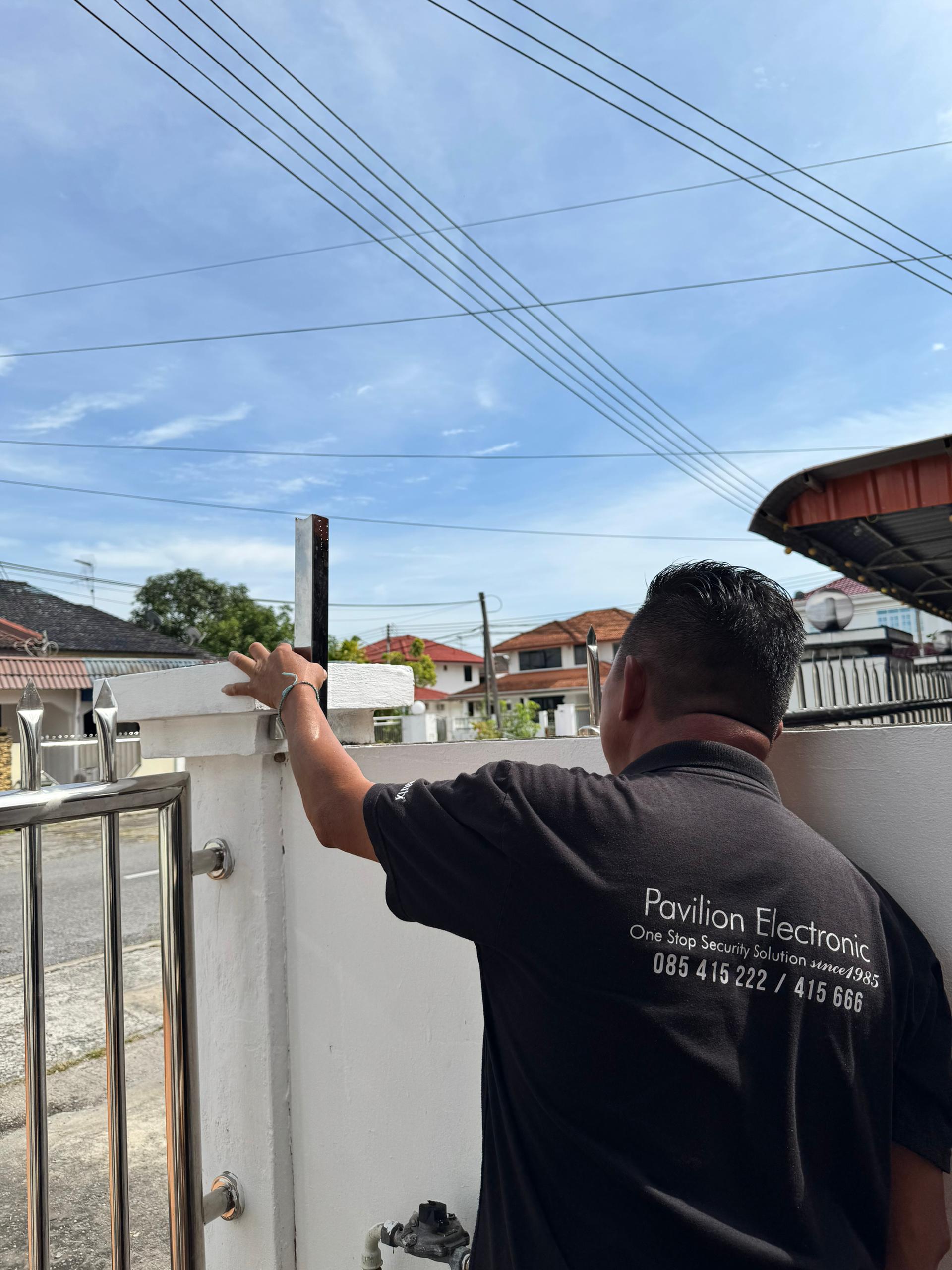 Pavilion Electronic technician marking post positions during an electric fence installation in Miri, Sarawak