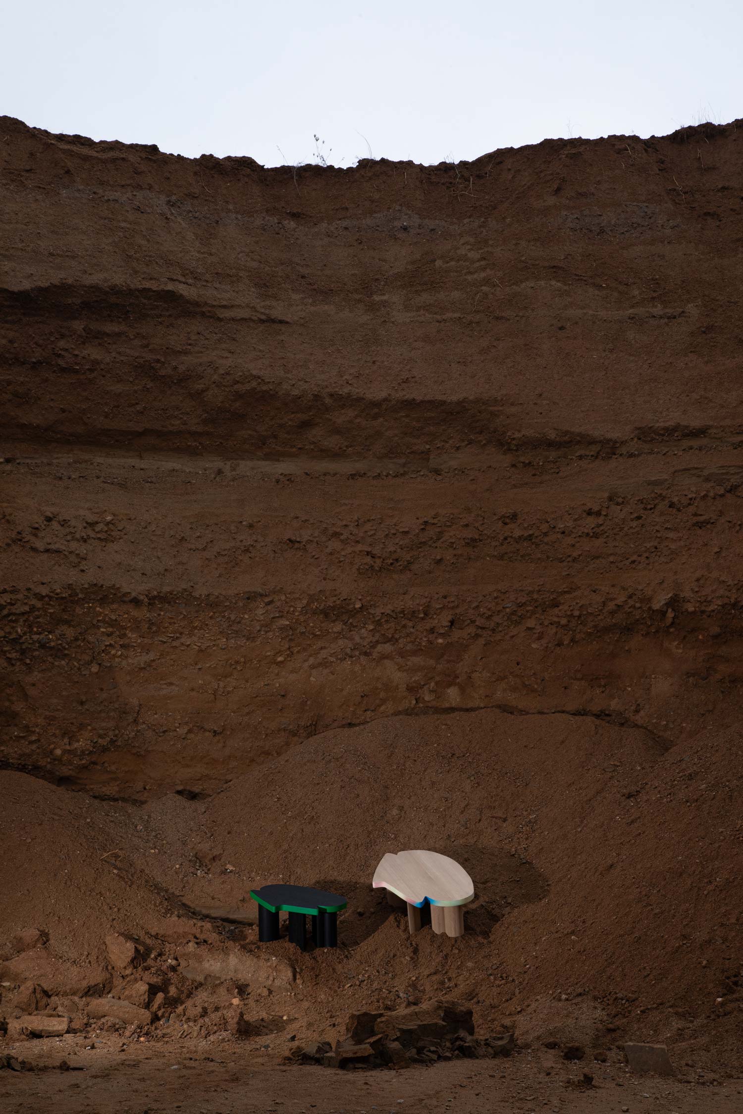 Cloudy Impromptu Noir and Pastorale coffee tables displayed together showing contrasting dark and multicolor finishes by Jiri Krejcirik
