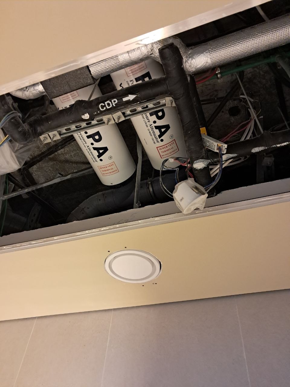 Open fan coil service hatch at Marina Gate.