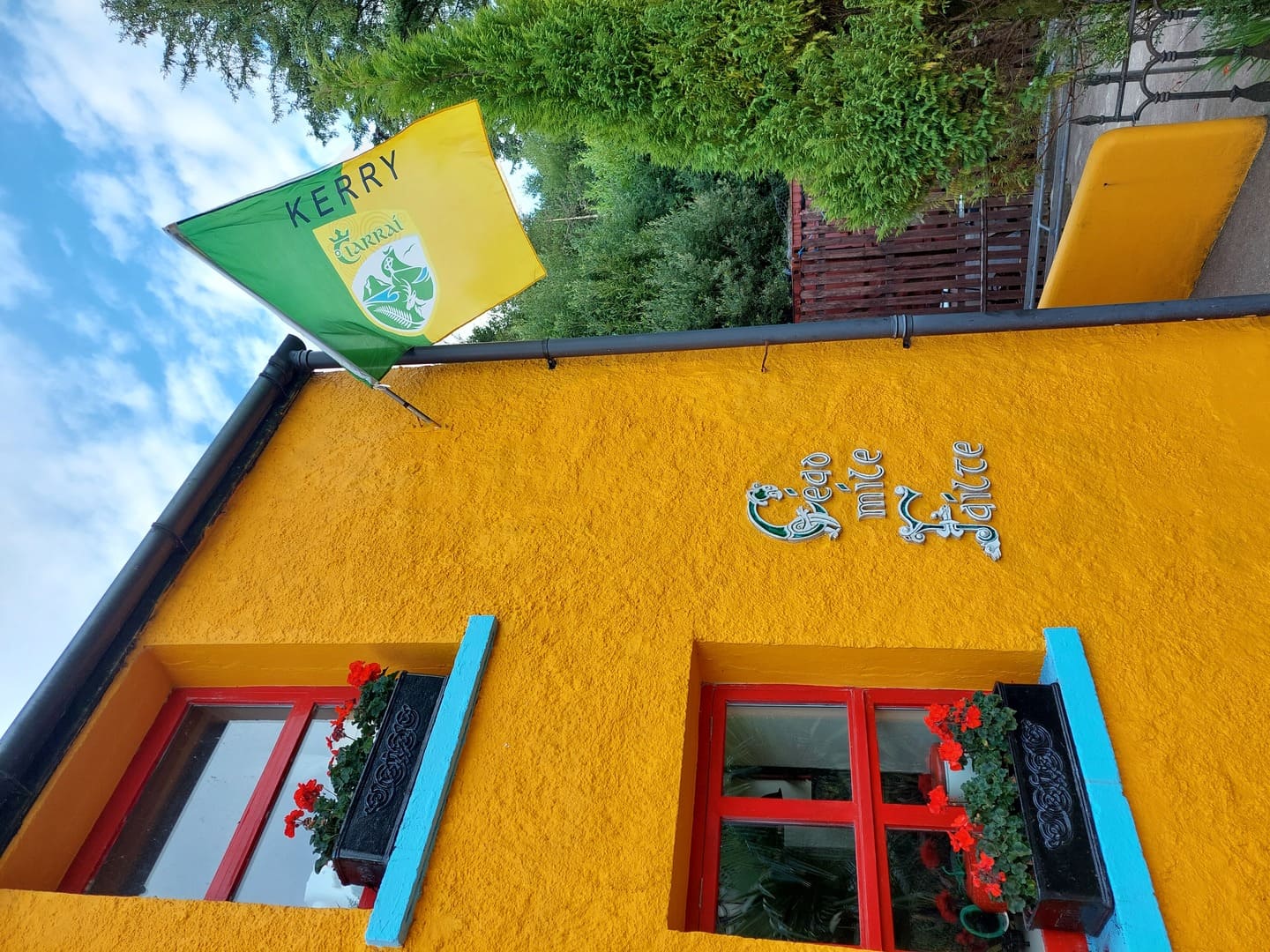 Exterior photo of the Strawberryfield wall that says 'Céad míle Fáilte'