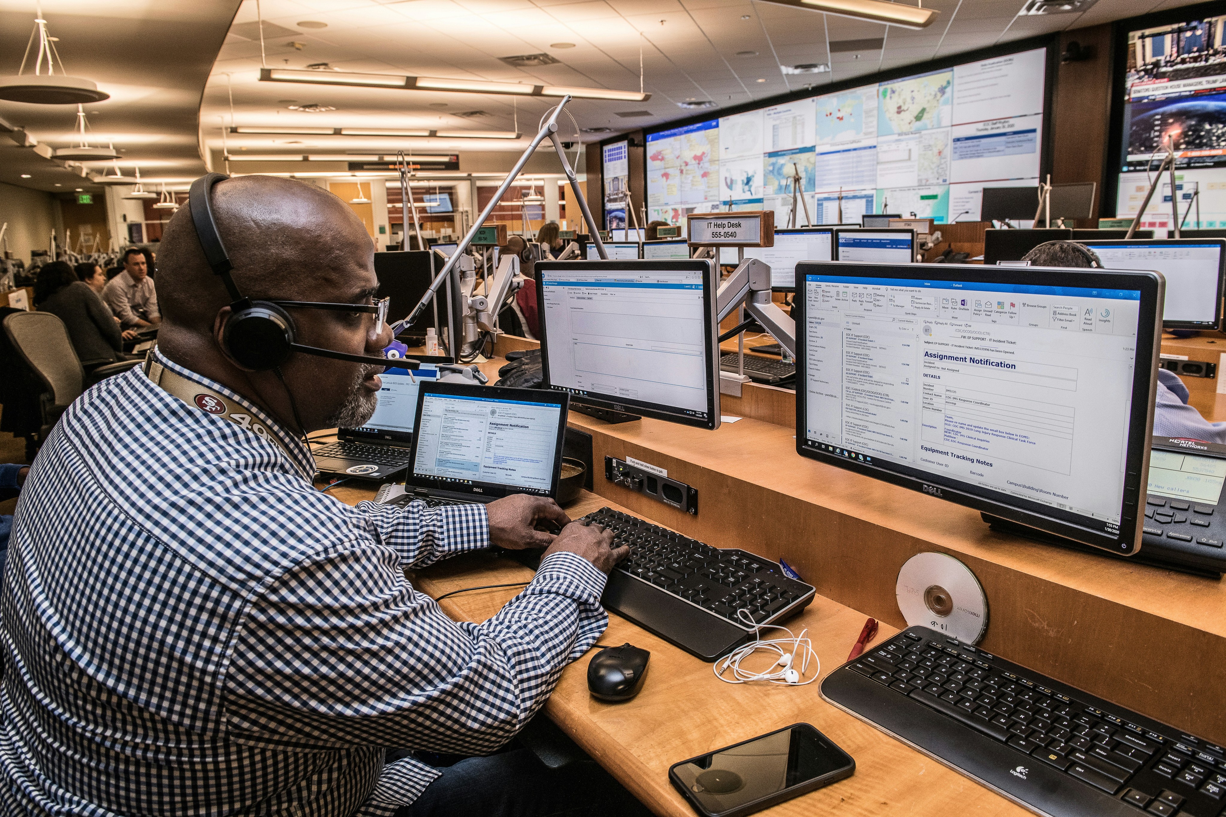 Team of BPO professionals collaborating over a computer, with a focused team leader explaining process optimizations to improve service delivery and client satisfaction