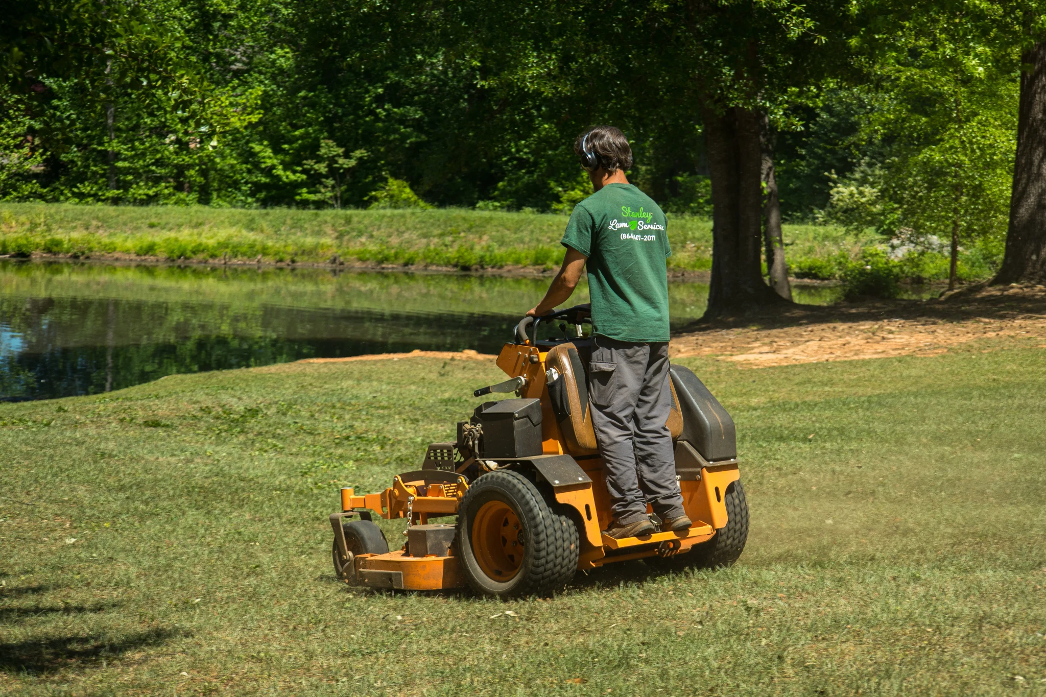 Professional lawn mowing service maintaining a residential yard in Greenville SC