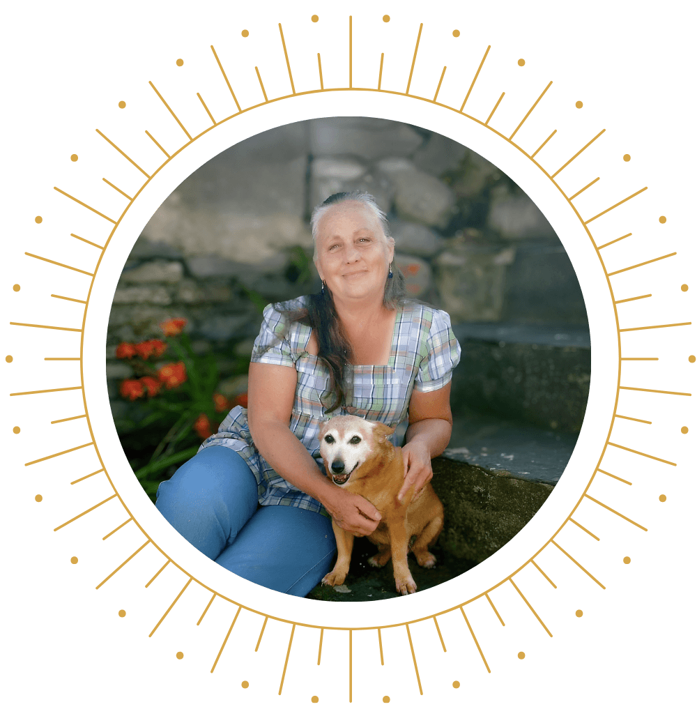 Carol Statham sitting on stairs with dog