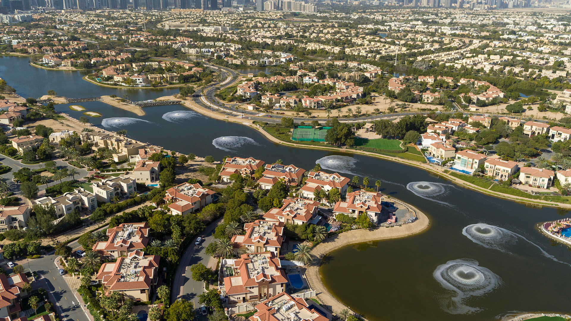 Aerial view of Jumeirah Islands, showcasing water and modern buildings in a vibrant urban landscape.