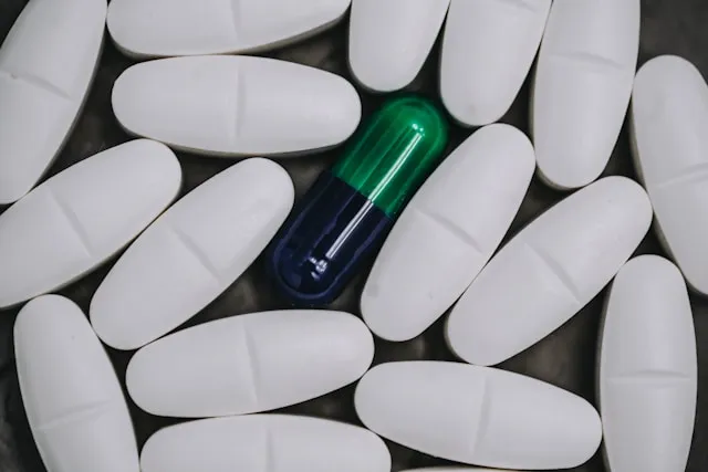 Vitamin B1 capsule surrounded by white tablets