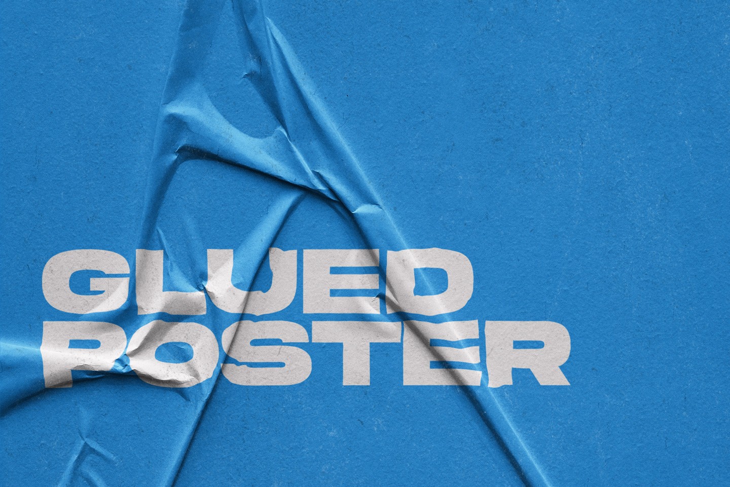 Close up of a glued poster effect on a bright blue wrinkled paper surface
