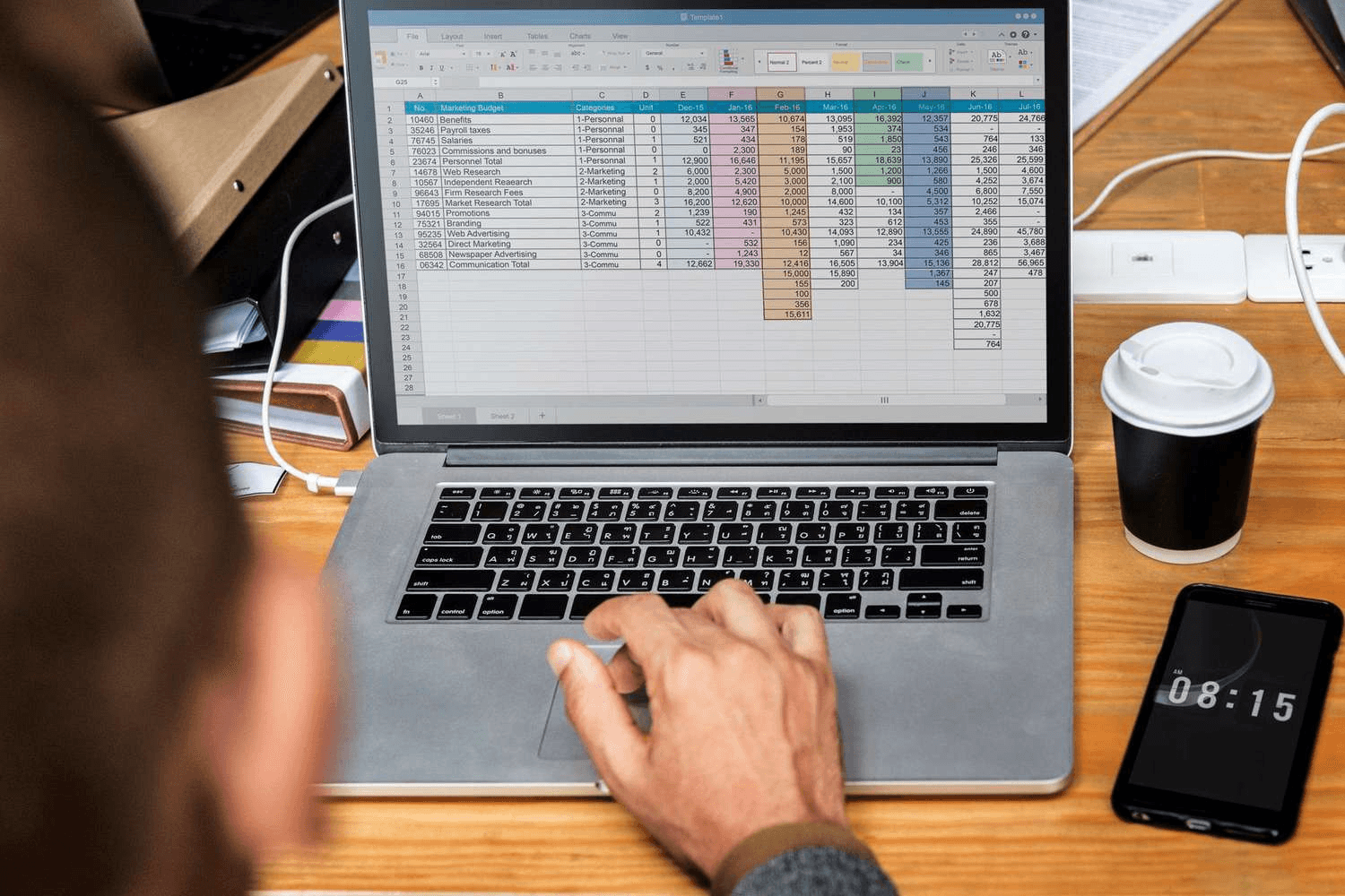 Man analyzing marketing budget on laptop - Building a Cash Flow Forecast Model in Excel