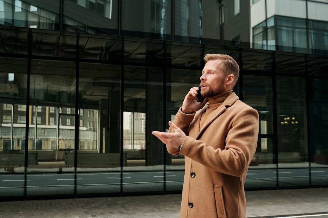 A confident professional taking a phone call by an office window