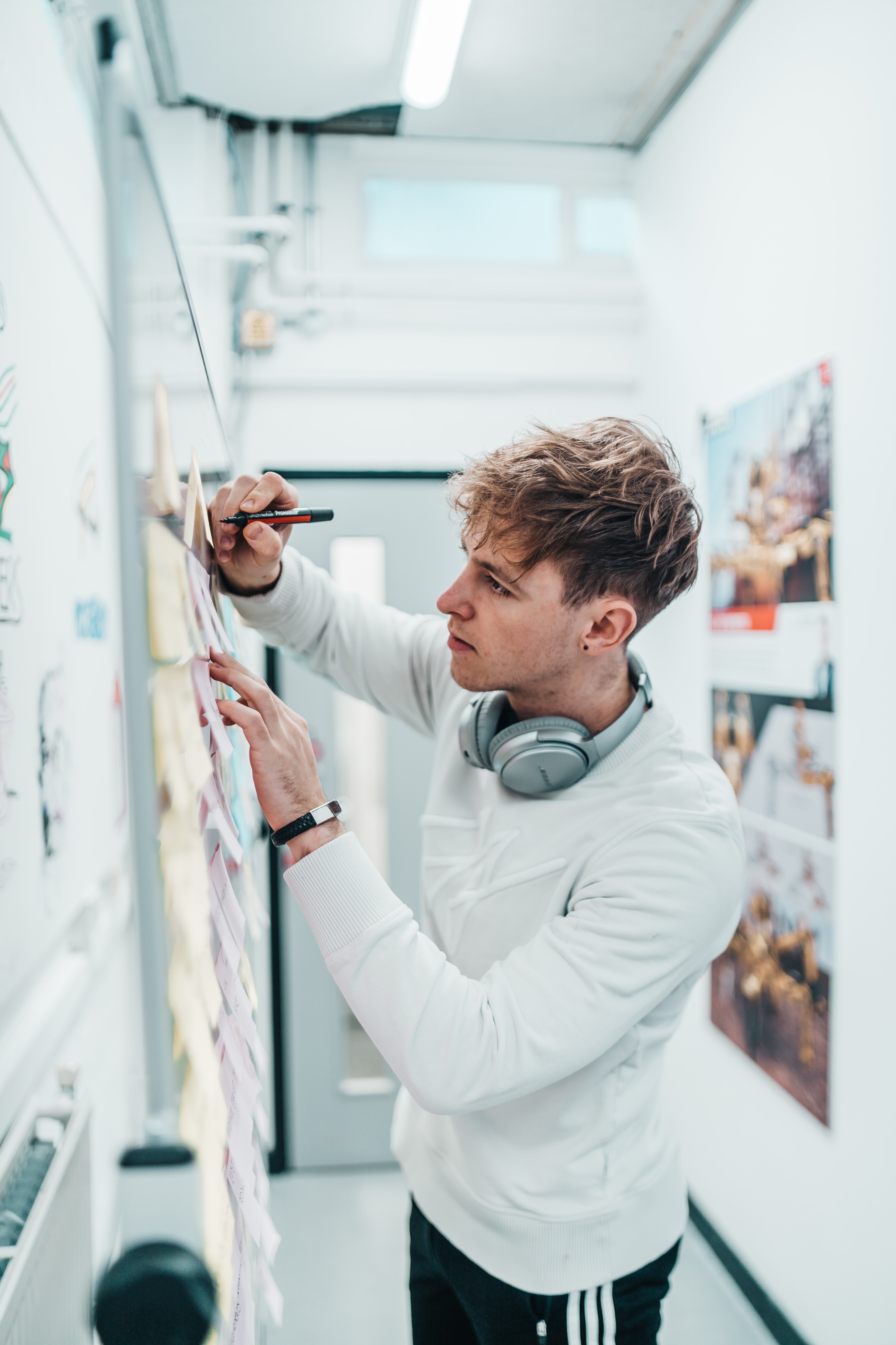 Young designer writing on a billboard