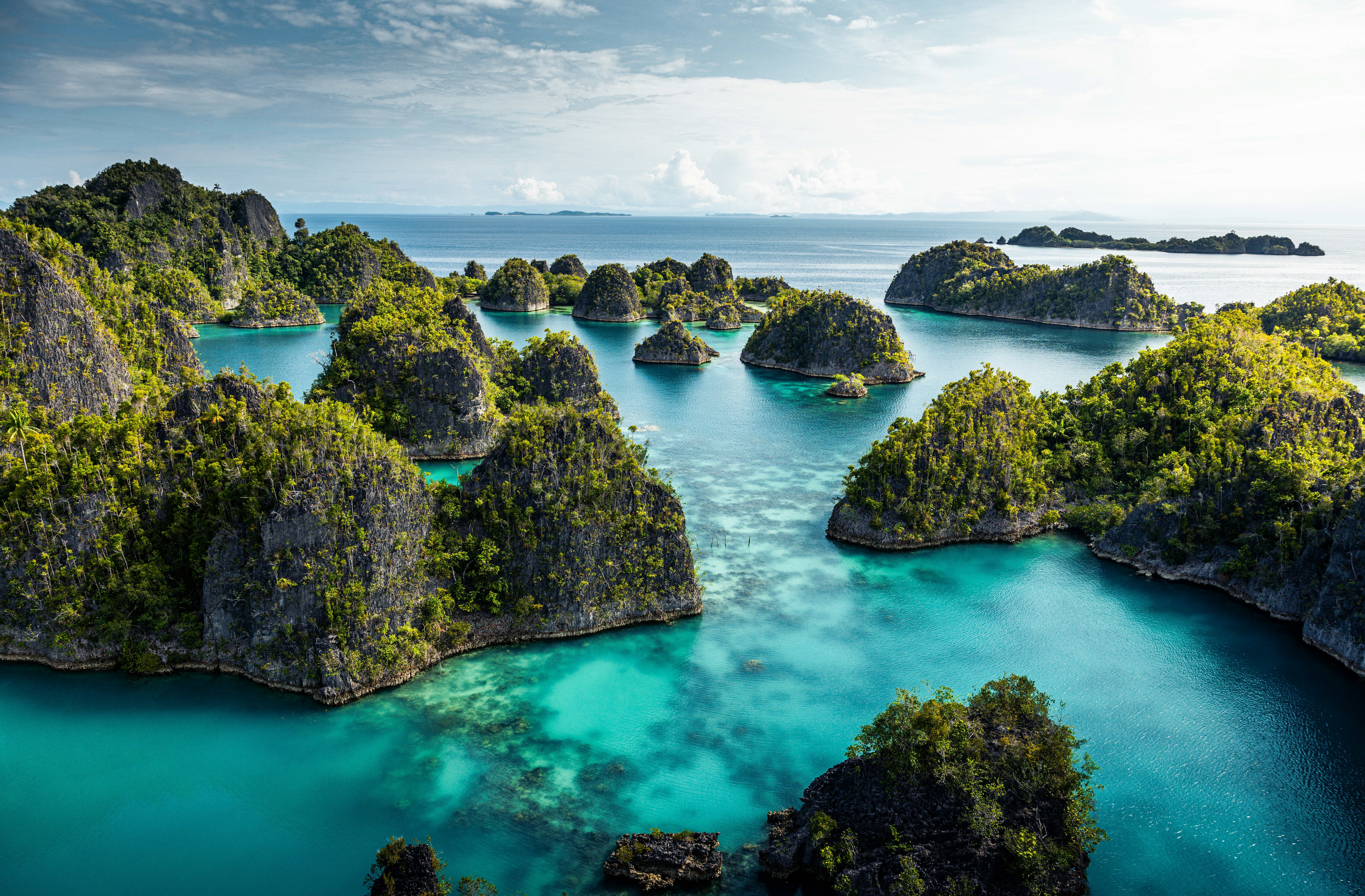 an aerial view of a body of water surrounded by rocks