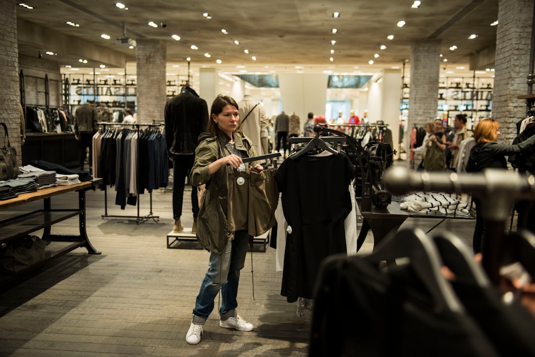 woman holding apparel inside shopping building