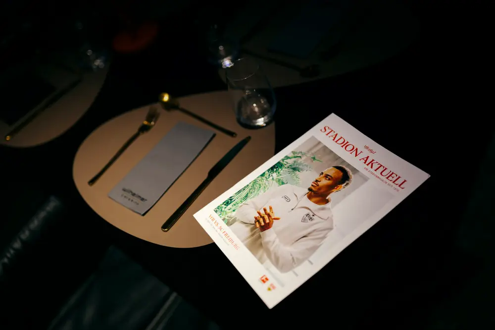 Stadium magazine STADION AKTUELL is laying on a table in the Porsche Tunnelclub inside the MHP Arena Stuttgart