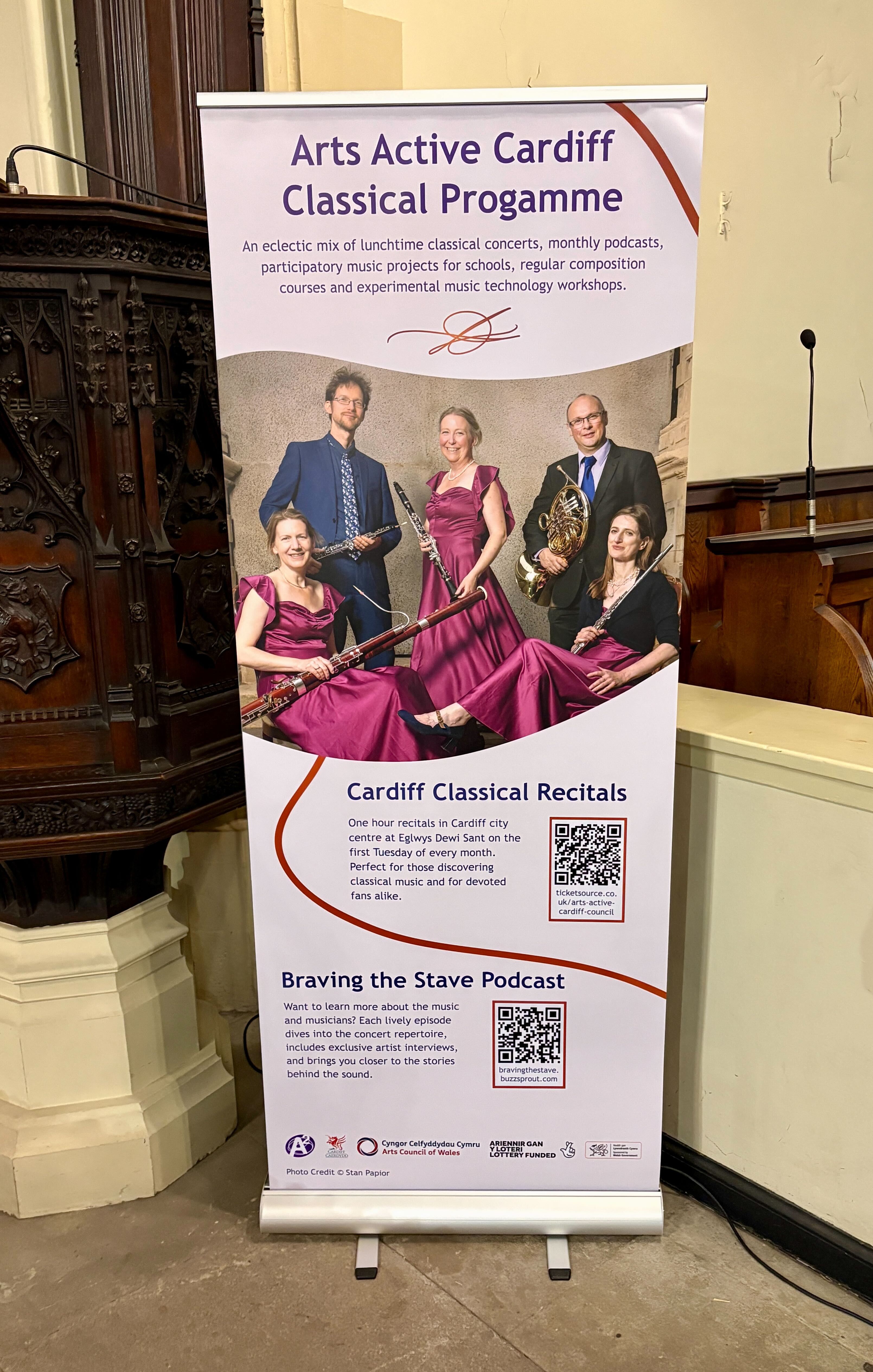 A pull up banner for Arts Active displaying an image of a group of musicians and text about the Cardiff Classical Programme.