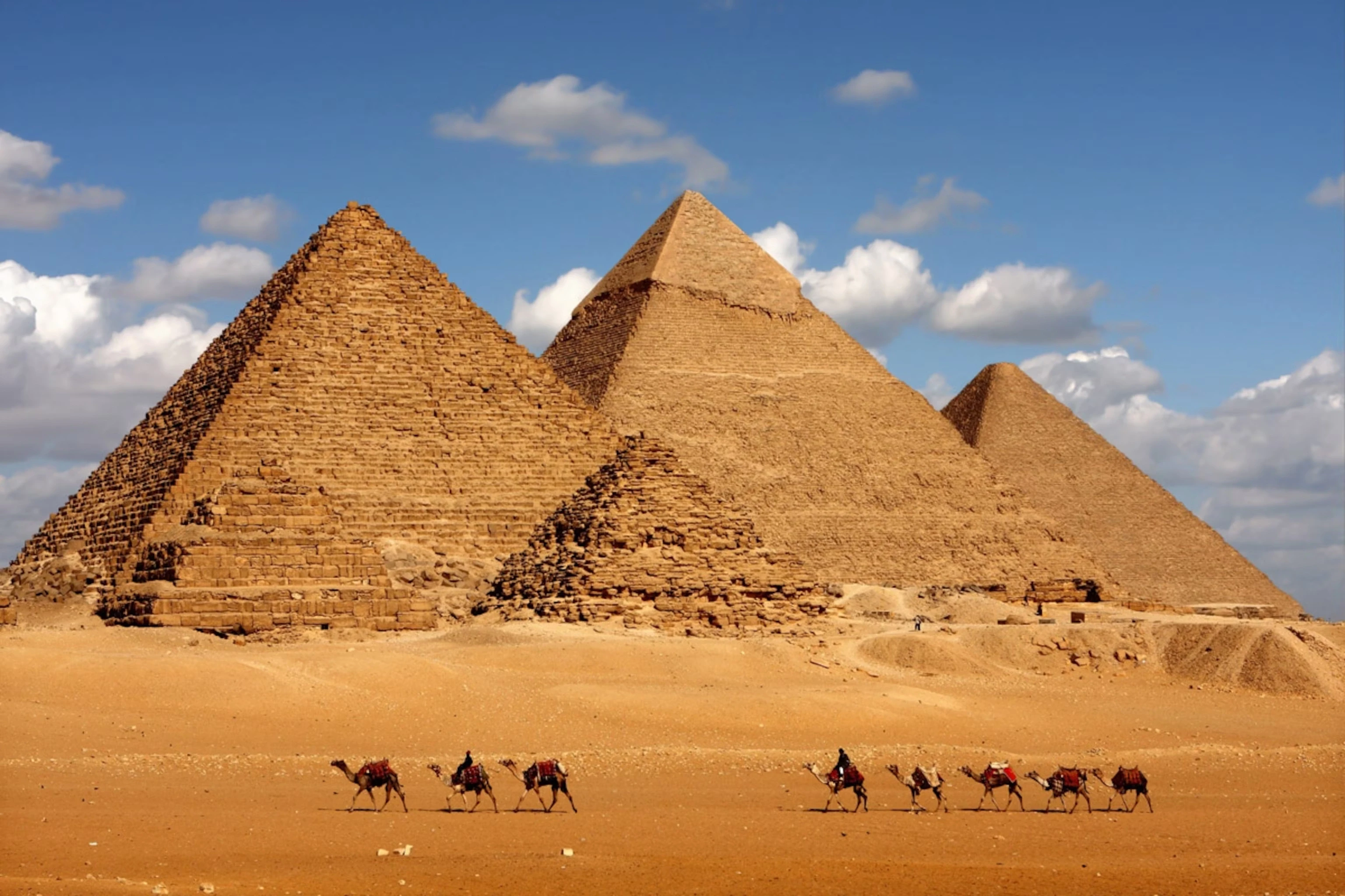 Pyramids and camel caravan in Giza Desert