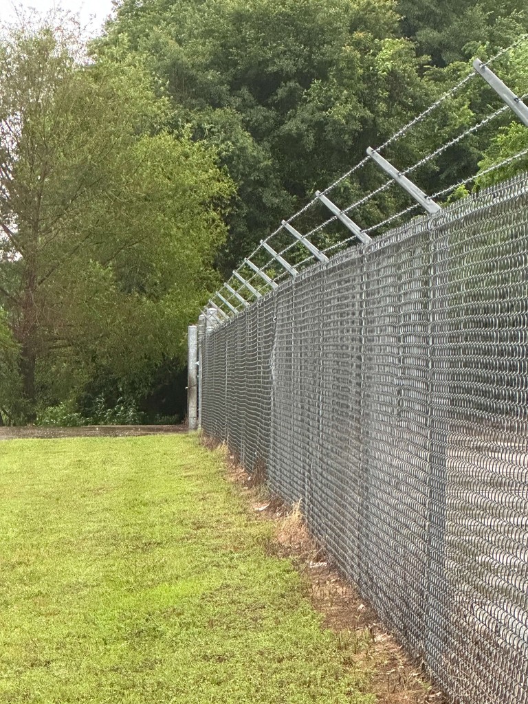 This picture shows a security fence with razor wire at the top that we can install around properties.  We also run security fencing from our welding and fabrication shop in Henderson, Texas.