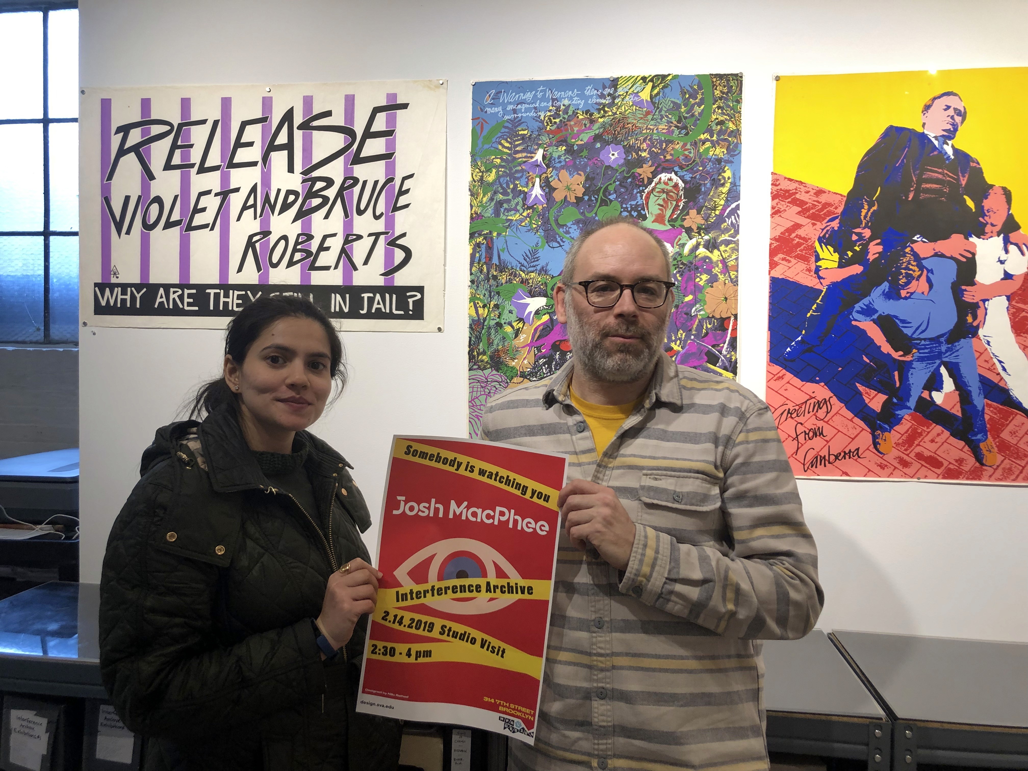 Josh MacPhhee and a student holding a poster together