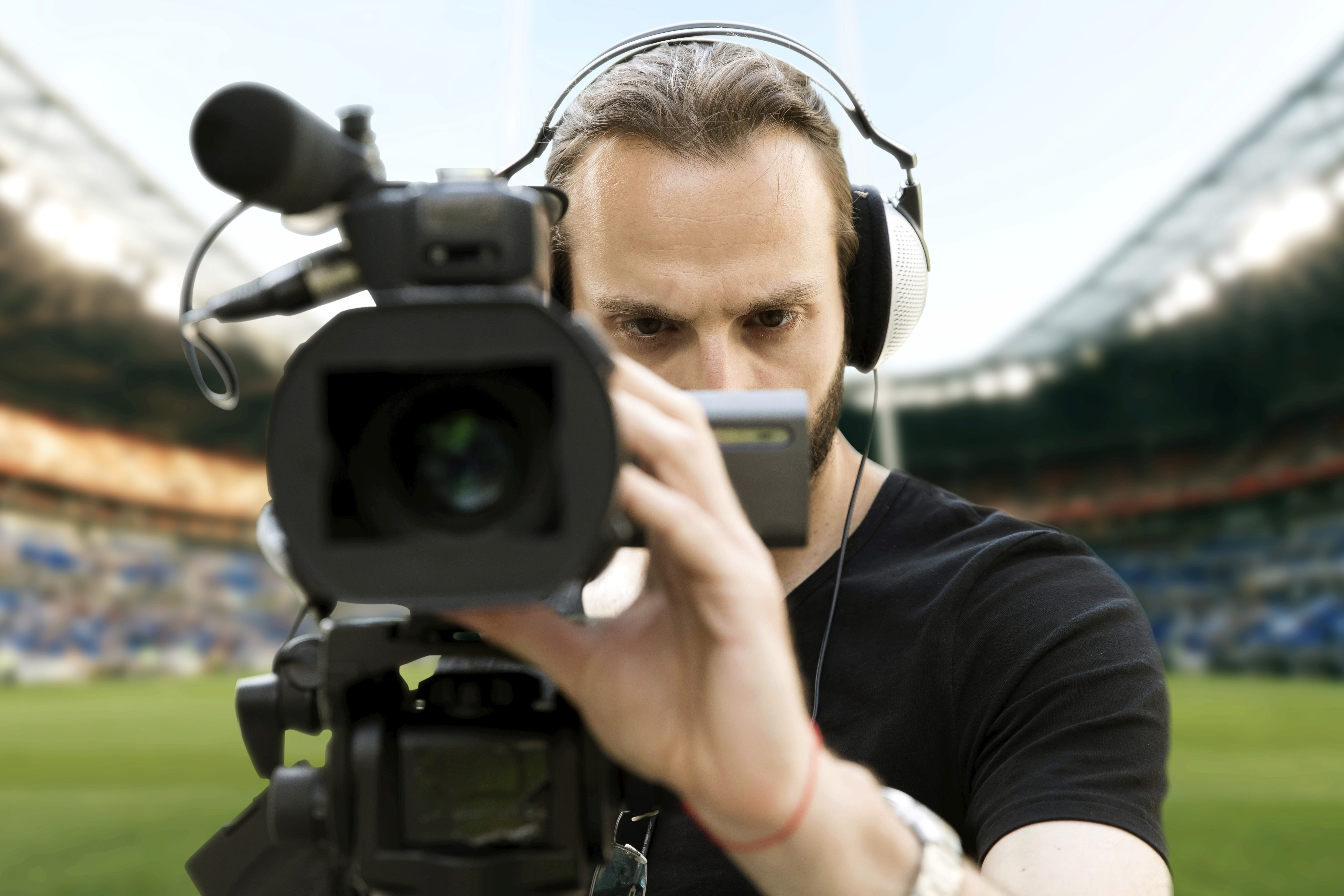 Camera man filming a sport match