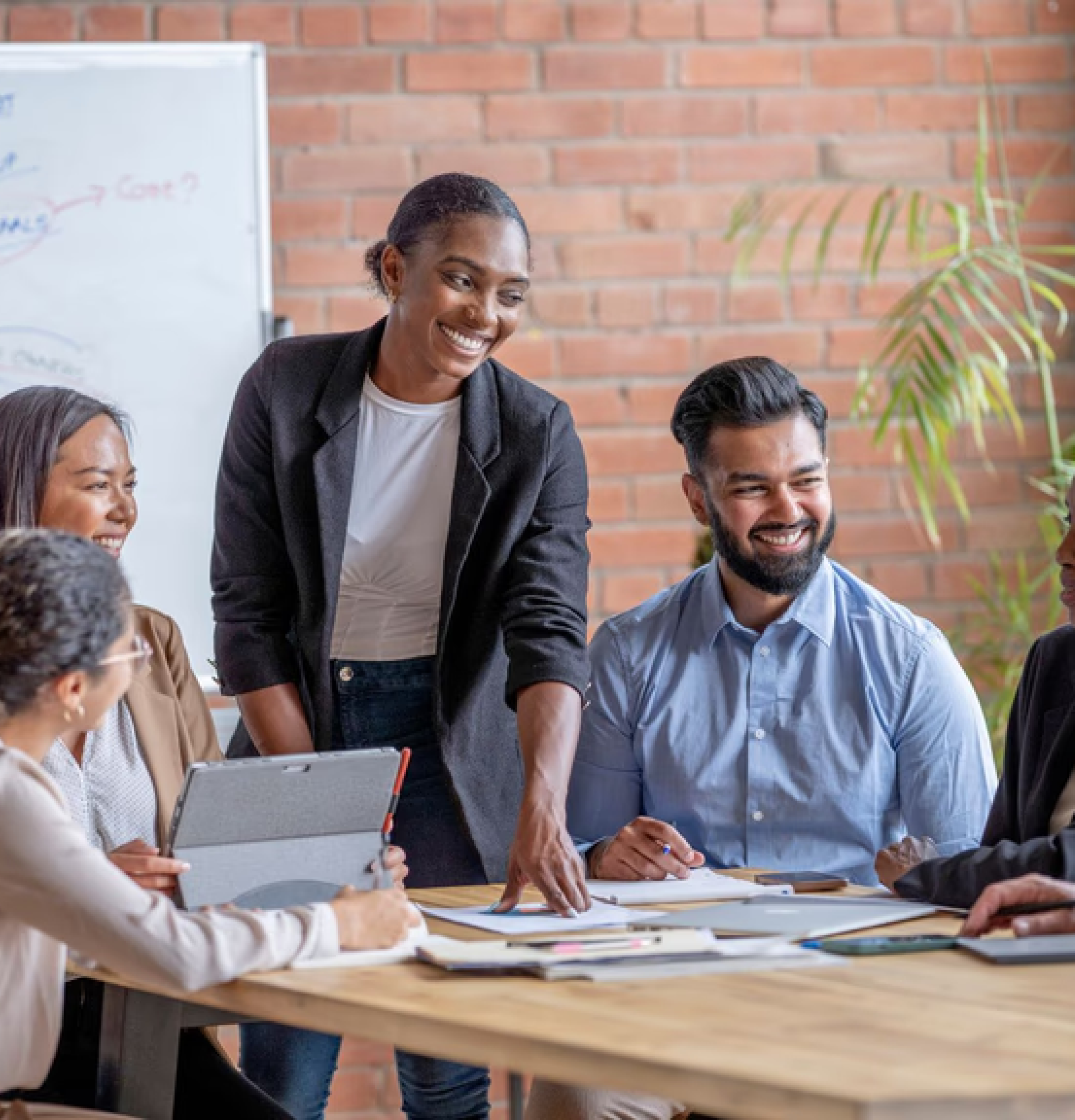 Team discussing in front of a whiteboard