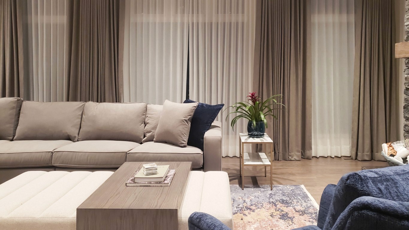 Image of Luxury living room interior design by KHD Homes featuring sofa, furniture, and window coverings.