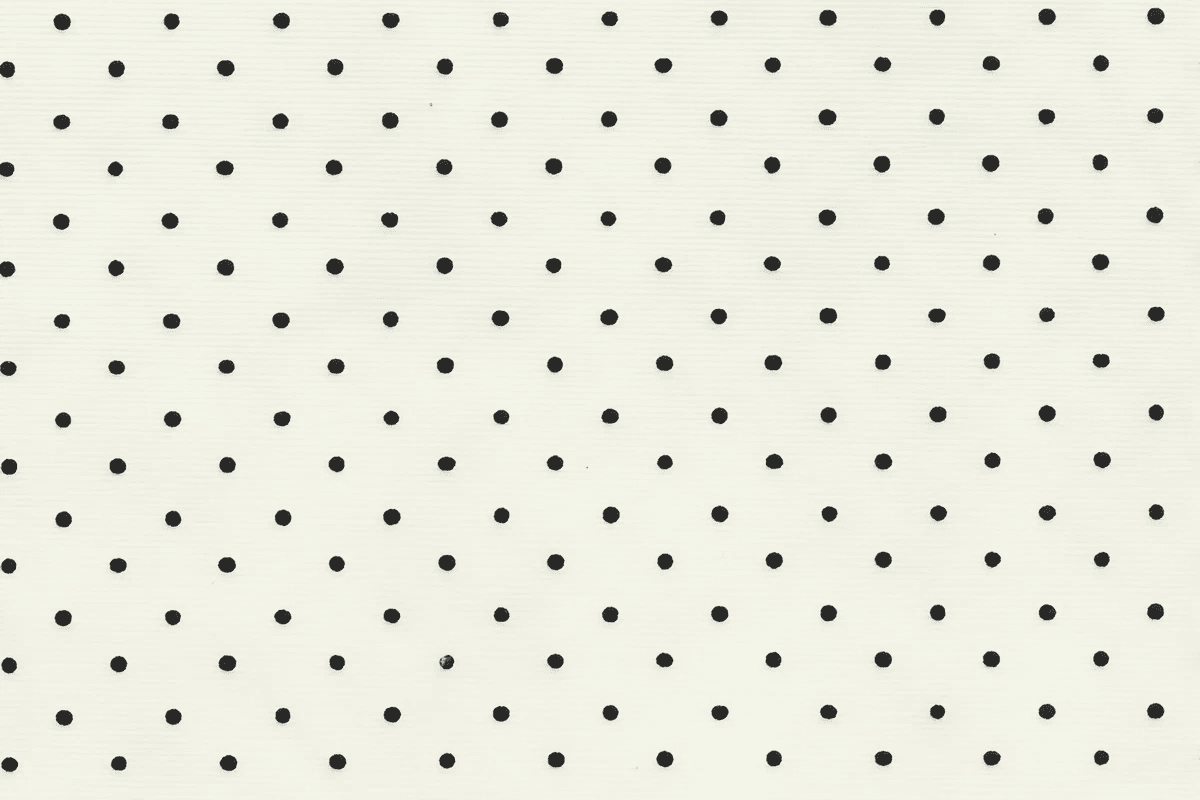 The image features an off-white background adorned with evenly spaced small black polka dots, creating a classic and minimalist pattern.