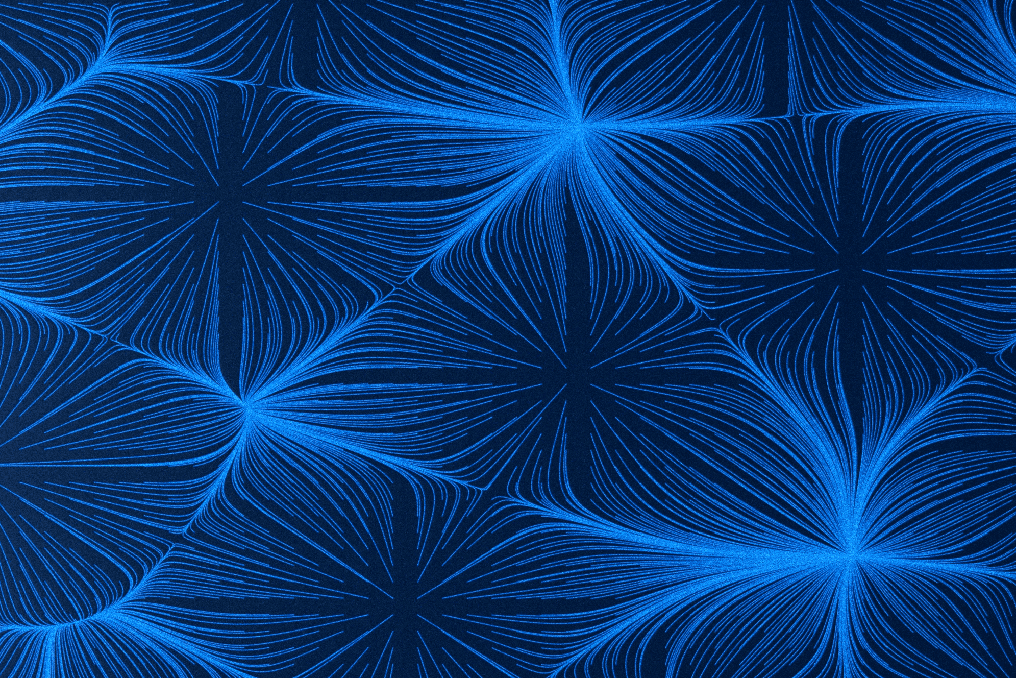 Black and white image of people working at a table with laptops, showing hands gesturing during discussion of digital content displayed on screens, with fabrica® logo in the corner.