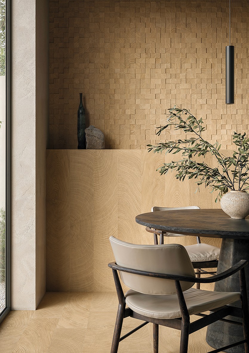 Close-up of a man’s legs wearing white and blue athletic sneakers, stepping through a field of yellow wildflowers under a partly cloudy sky.